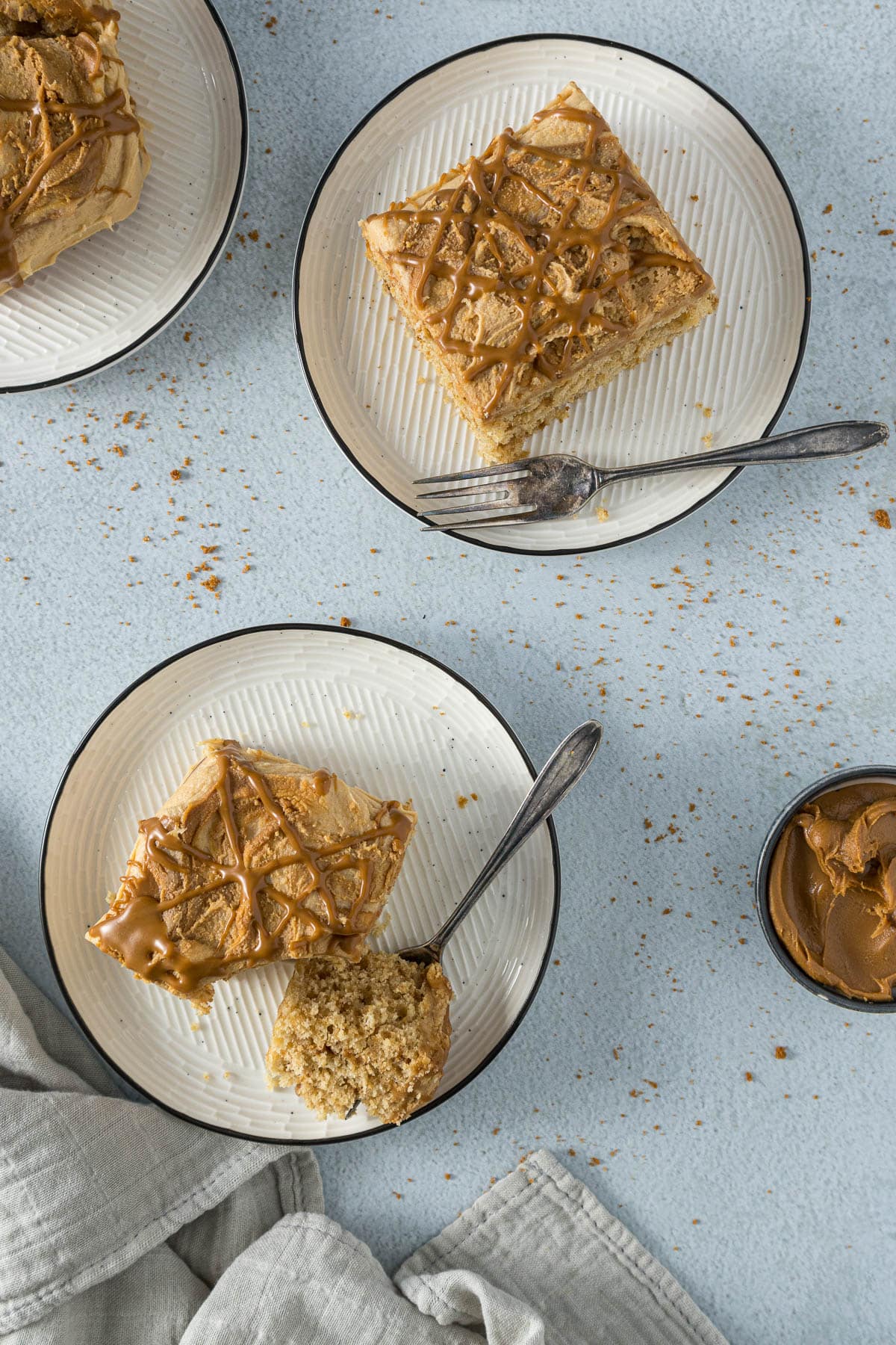 Slices of Biscoff cake on plates.
