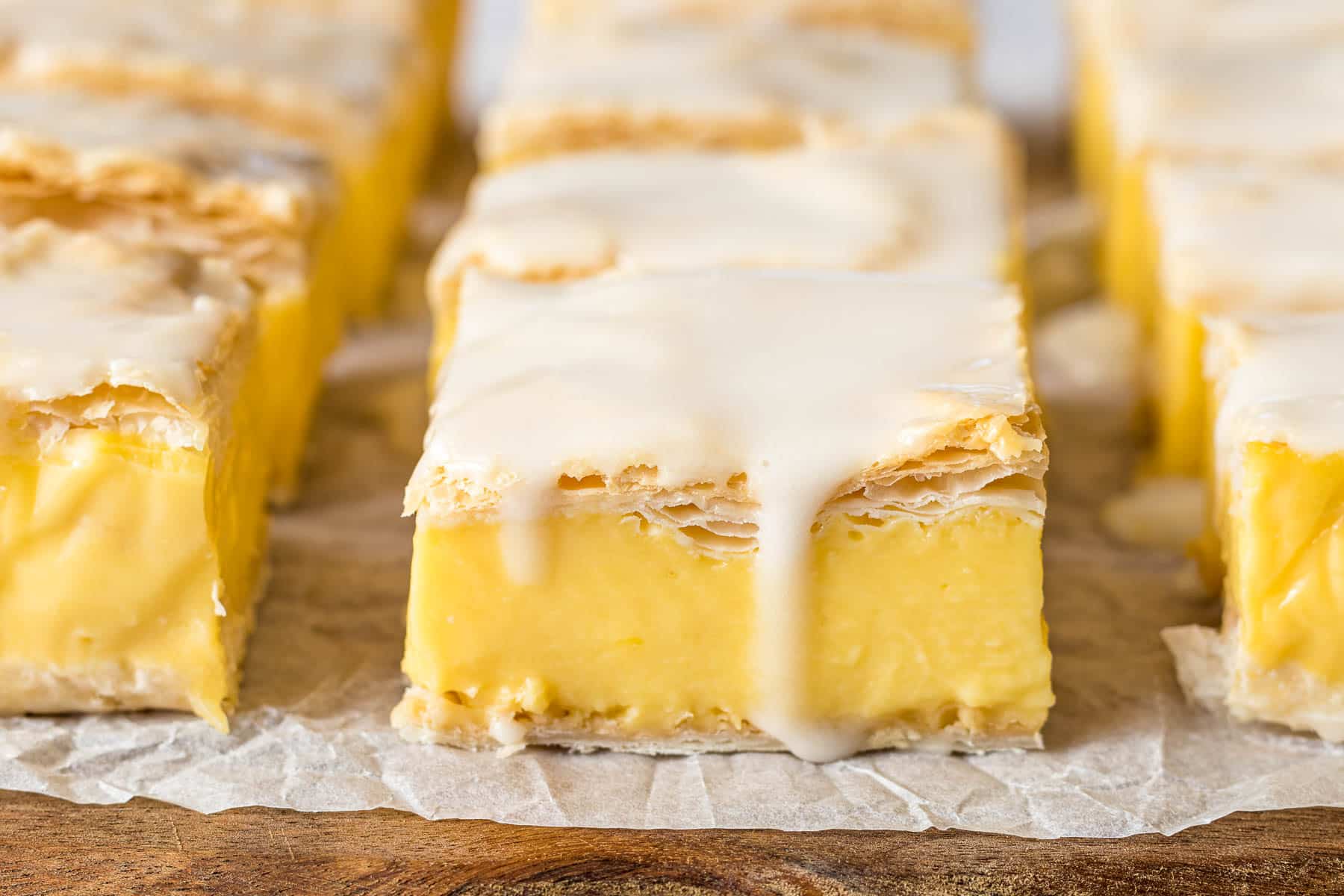 Vanilla custard slice topped with an icing glaze.