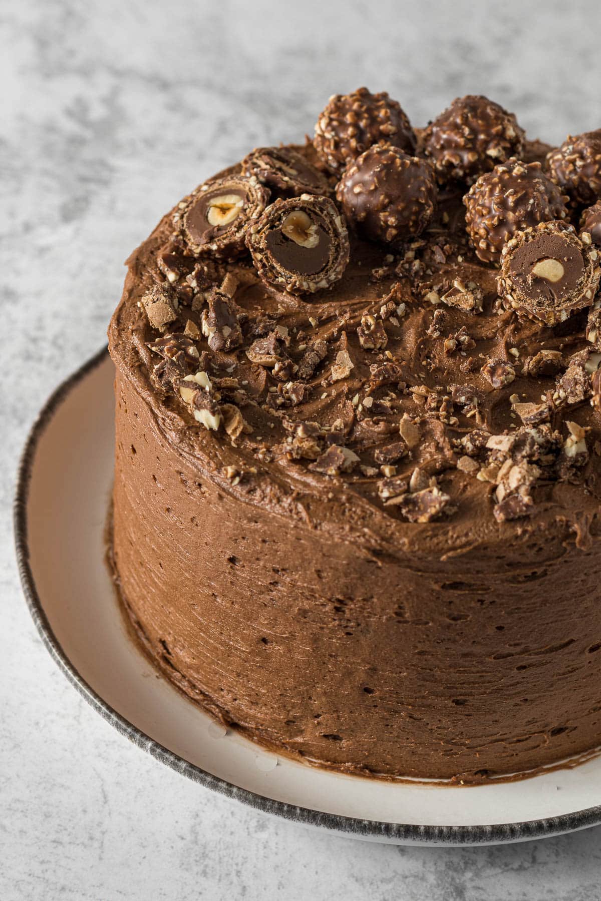 Decorated Ferrero Rocher cake on a plate.
