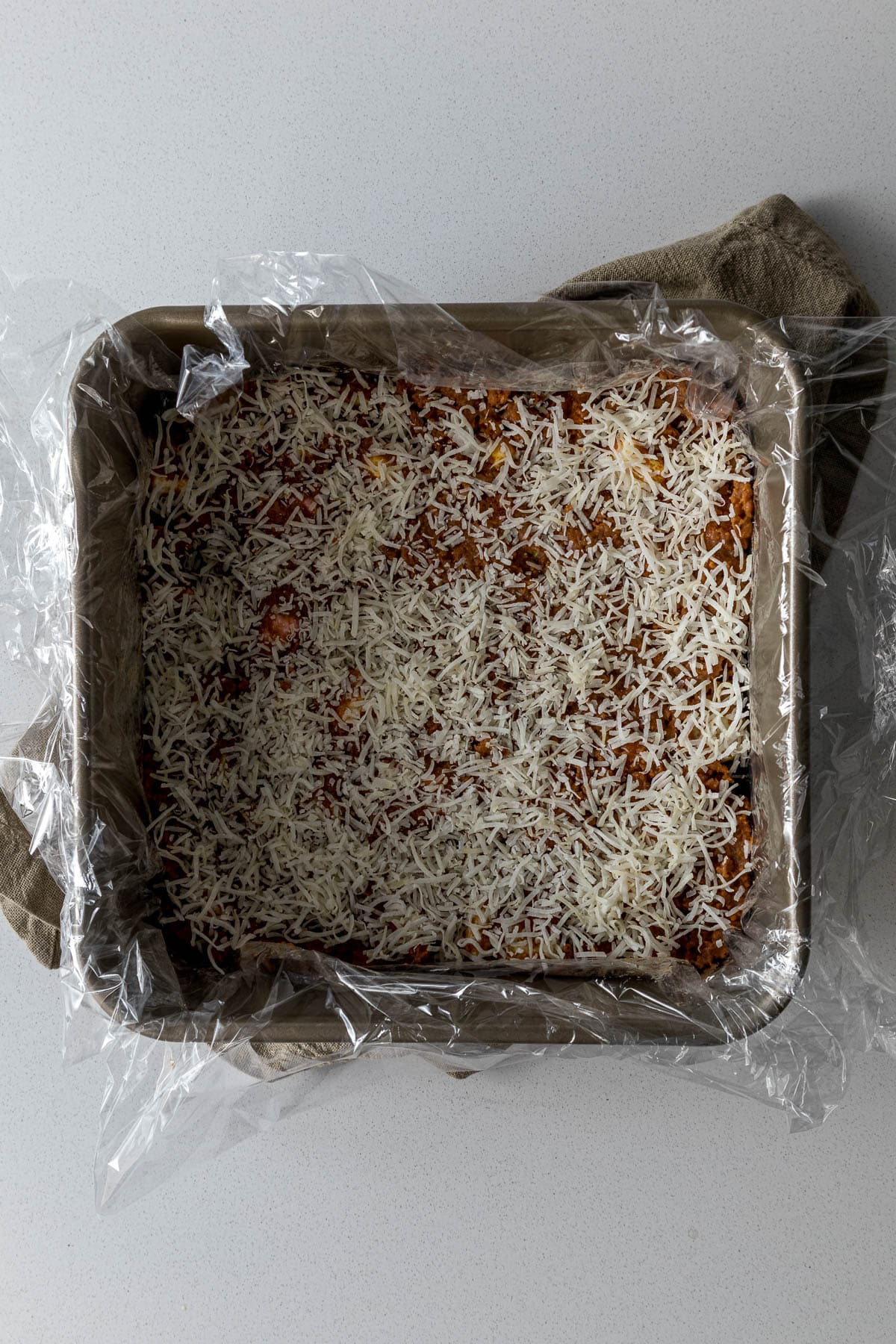 Lolly cake mixture pressed into cake tin and topped with coconut.