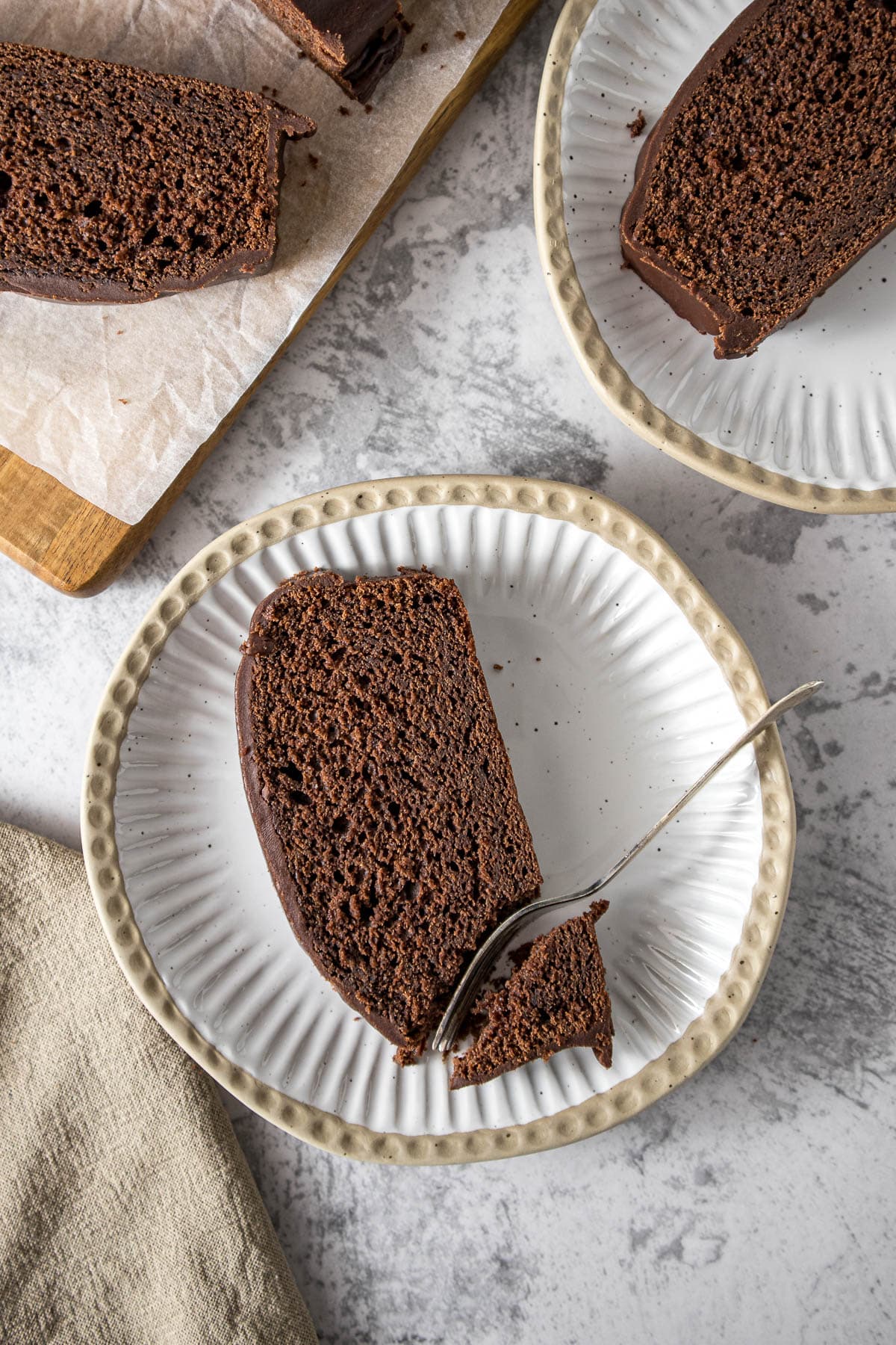 Slice of chocolate loaf cake on a plate.