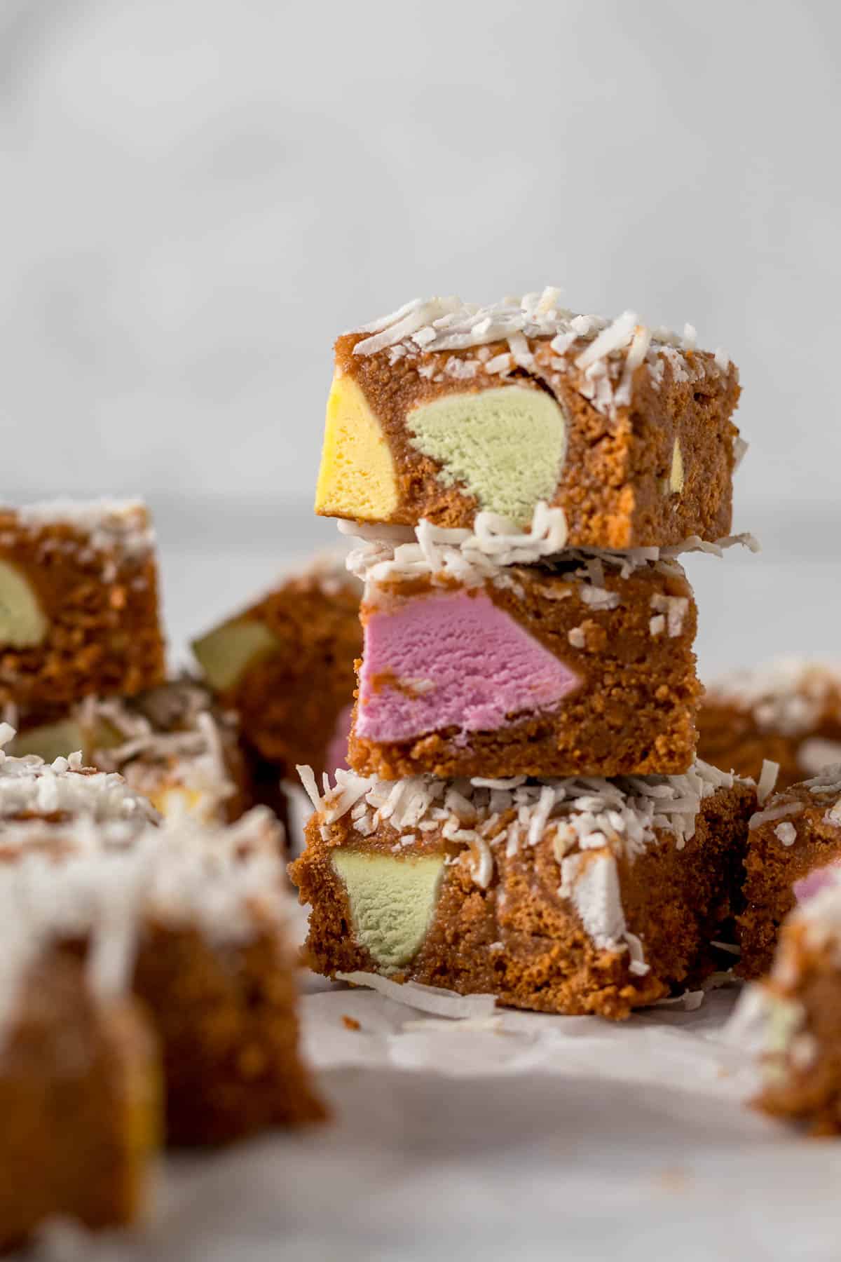 Three pieces of sliced lolly cake stacked on each other.