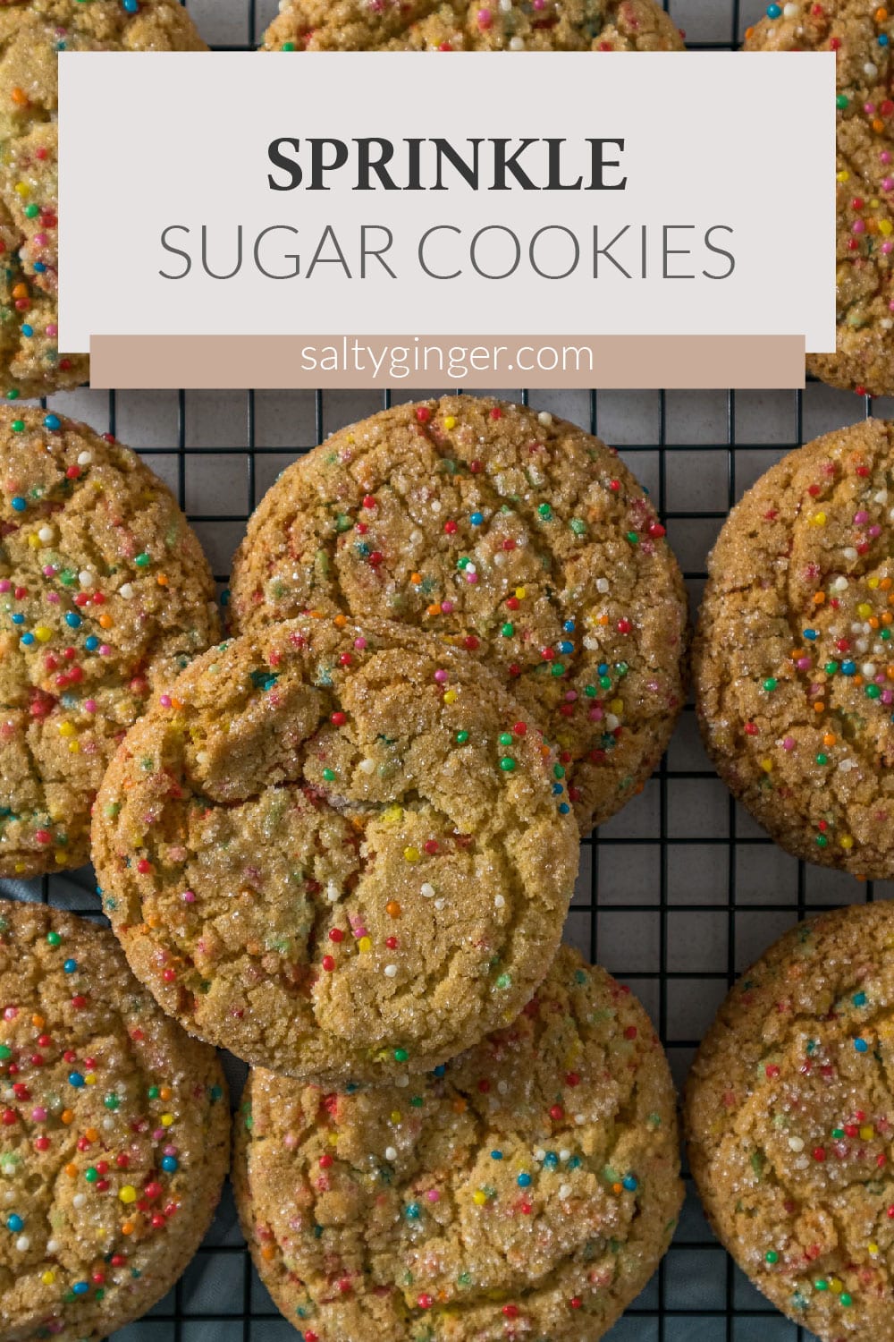 Sugar cookies with sprinkles on a cooling rack.