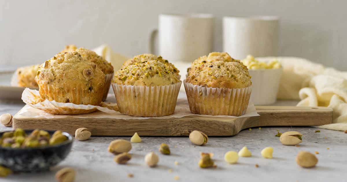 Pistachio muffins on a serving board.