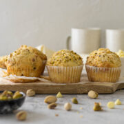 Pistachio muffins on a serving board.