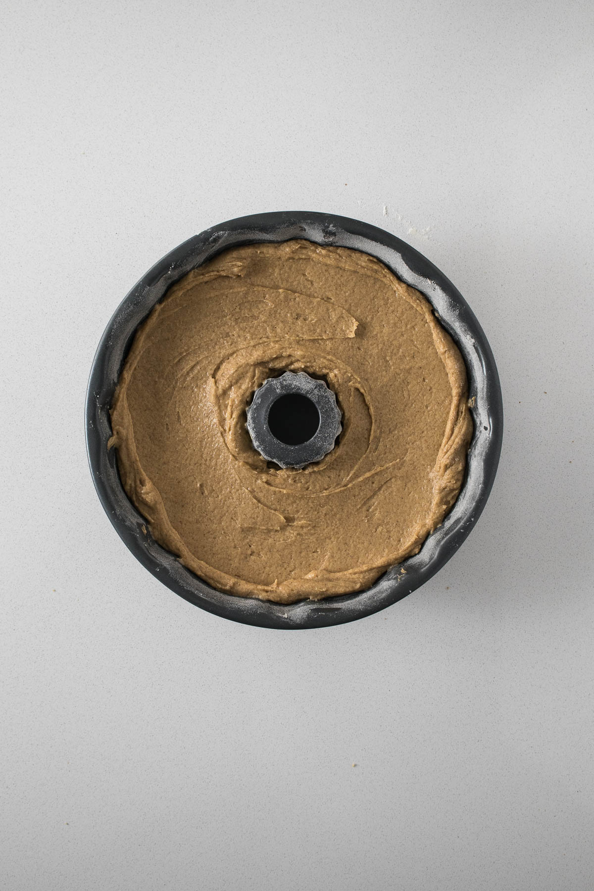 Step 6 - Second half of cake batter smoothed into the bundt tin.