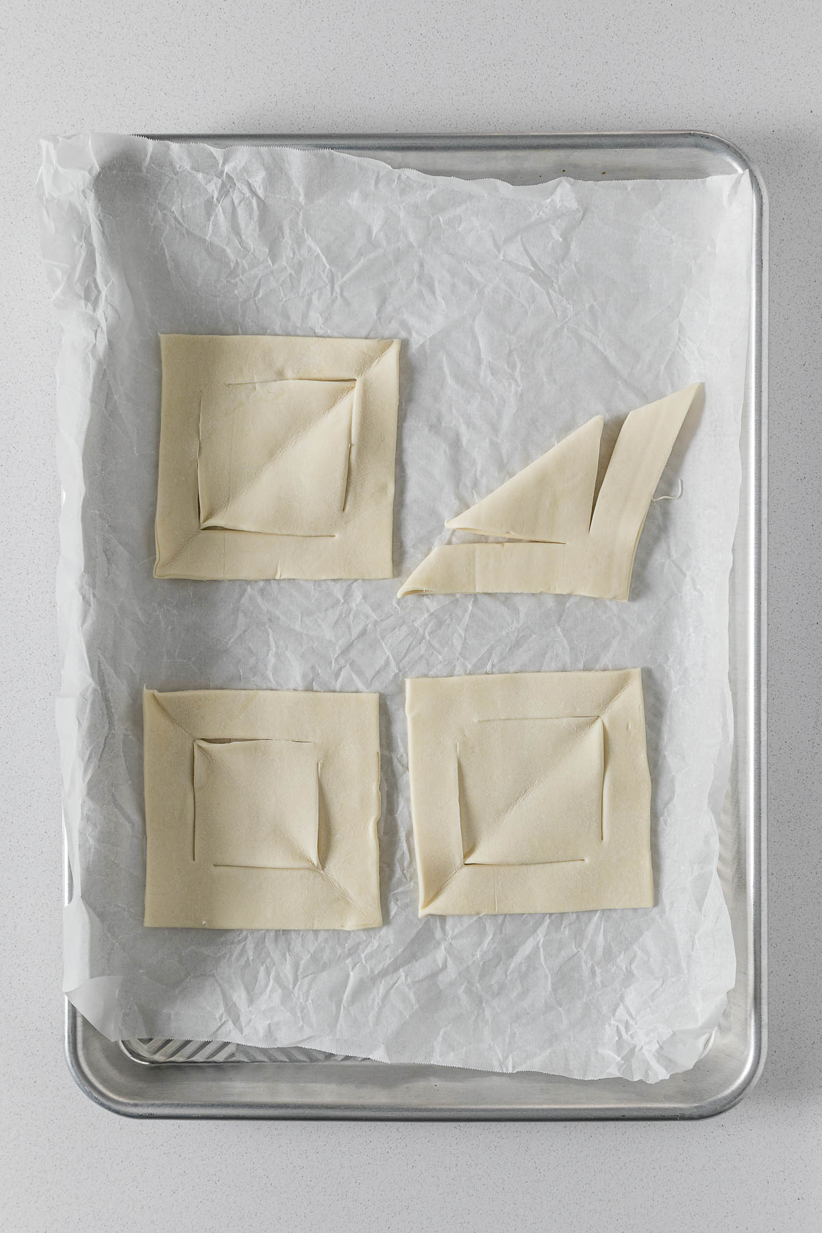 Step 5 - pastry folded in half with the borders cut almost all the way through.