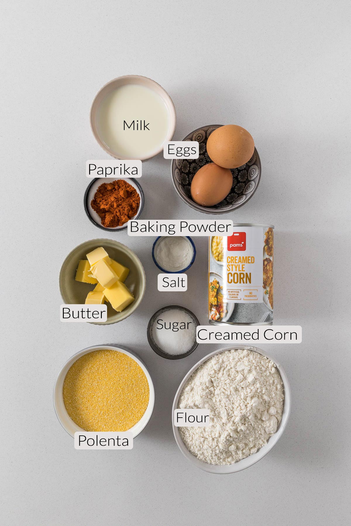 Mealie bread ingredients - flour, polenta, eggs, milk butter, creamed corn, salt, baking powder, paprika.