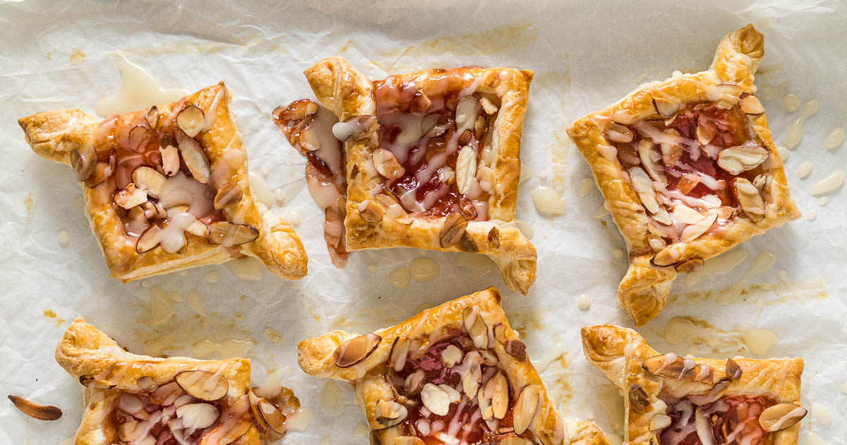 Baked jam puff pastry tarts topped with glaze.