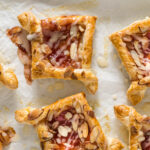 Baked jam puff pastry tarts topped with glaze.