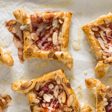 Baked jam puff pastry tarts topped with glaze.
