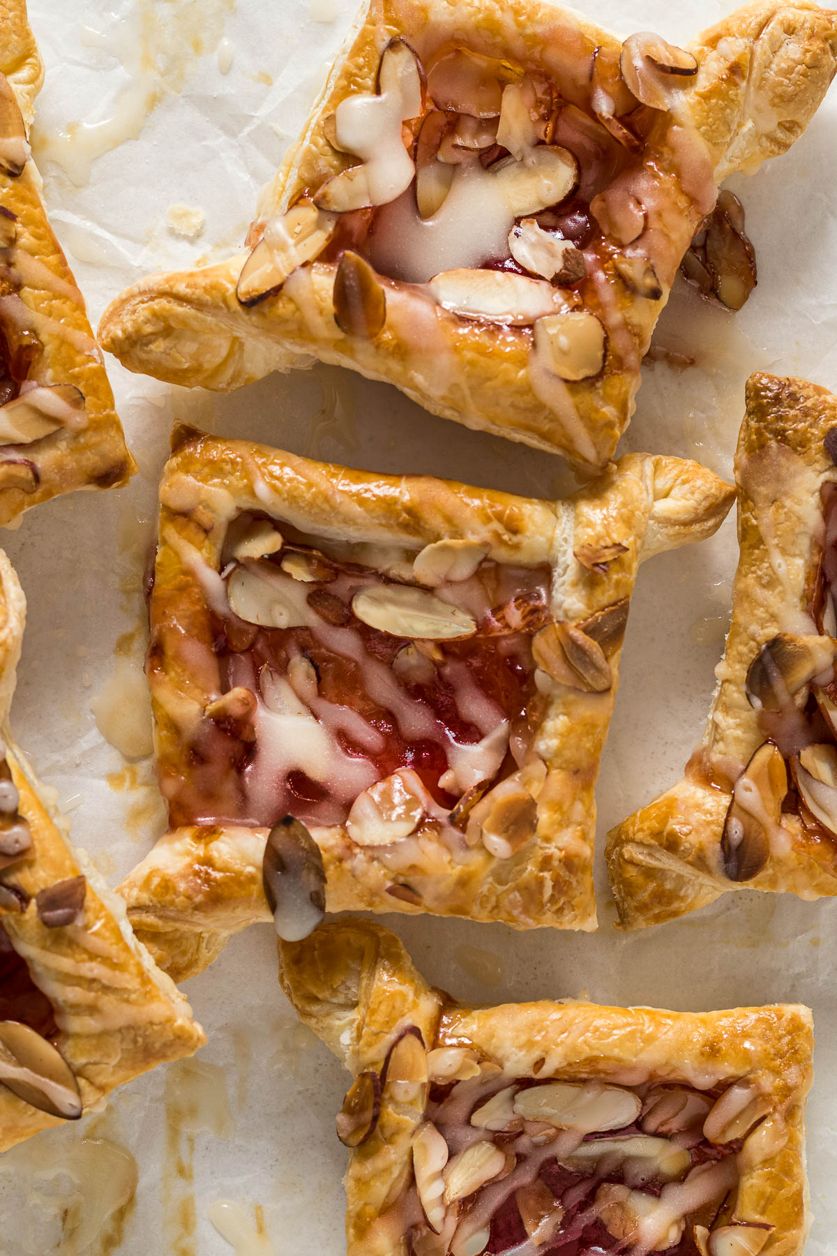 Baked jam puff pastry tarts topped with glaze.