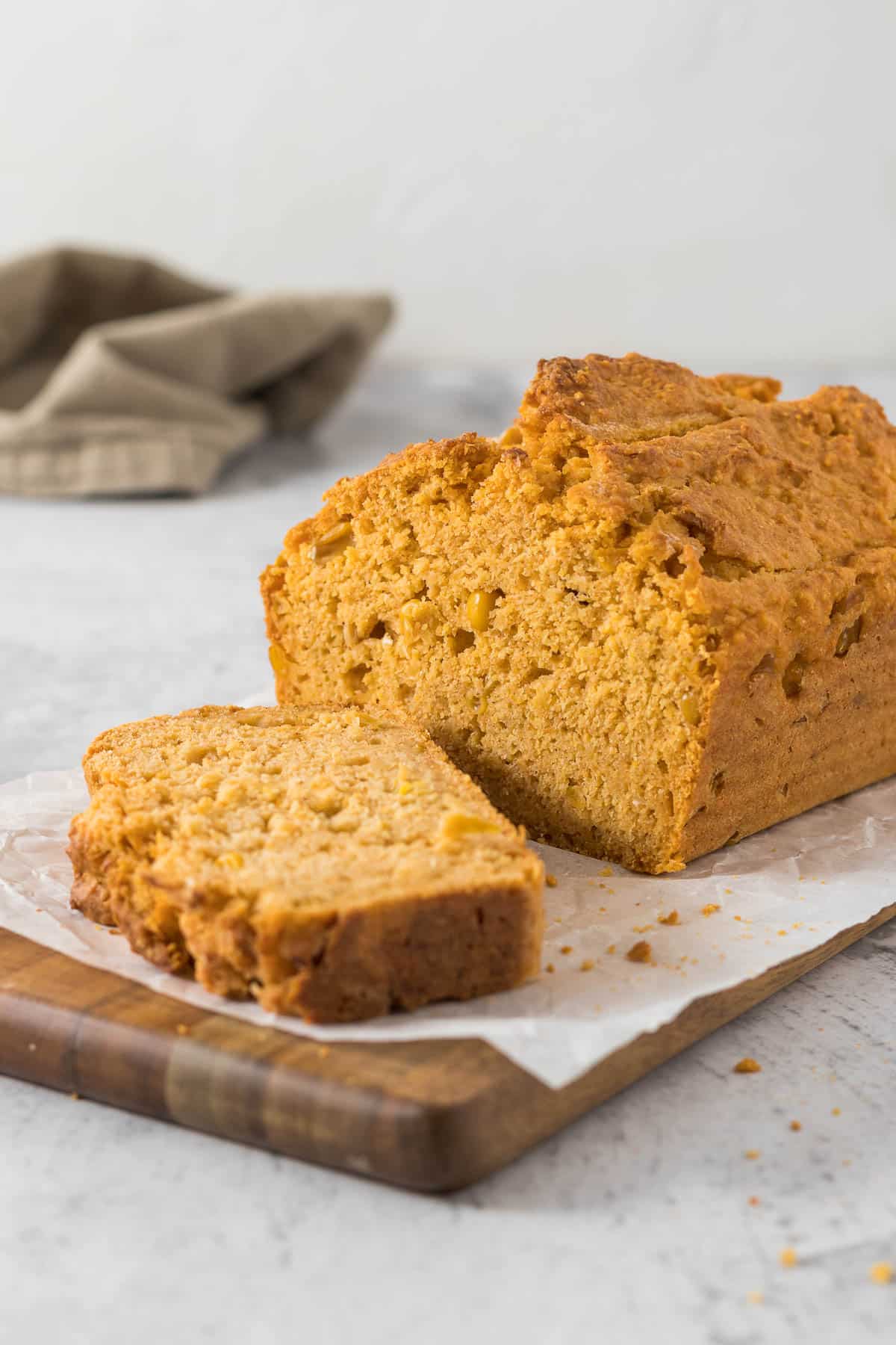 Sliced mealie bread on a bread board.
