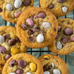 Cadbury Mini Eggs Cookies resting on a cooling rack.