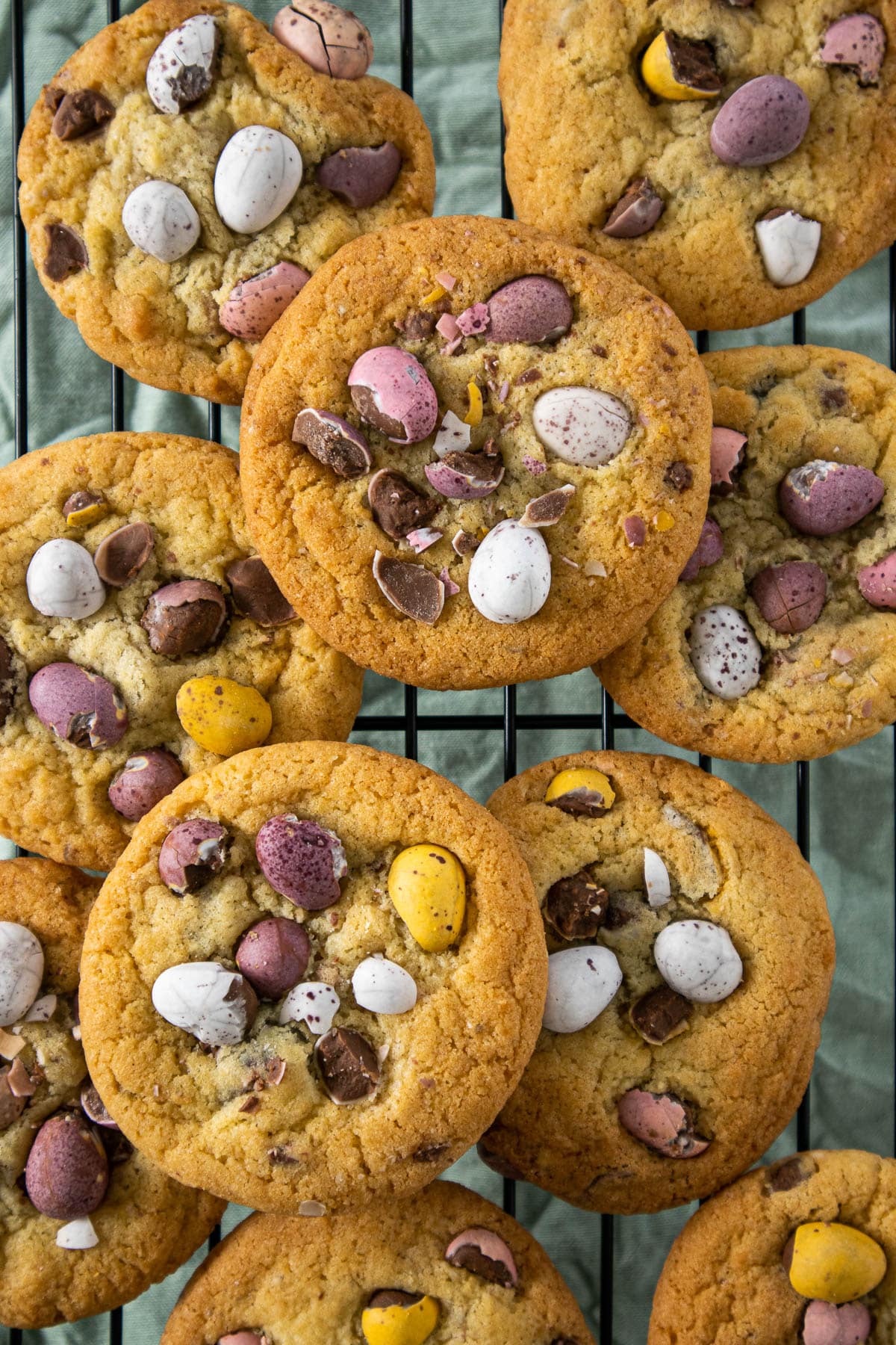 Cadbury Mini Eggs Cookies resting on a cooling rack.
