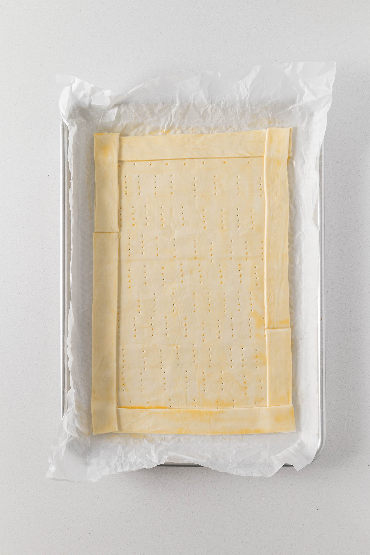 Step 6 - Puff pastry docked, with a border and egg washed. 