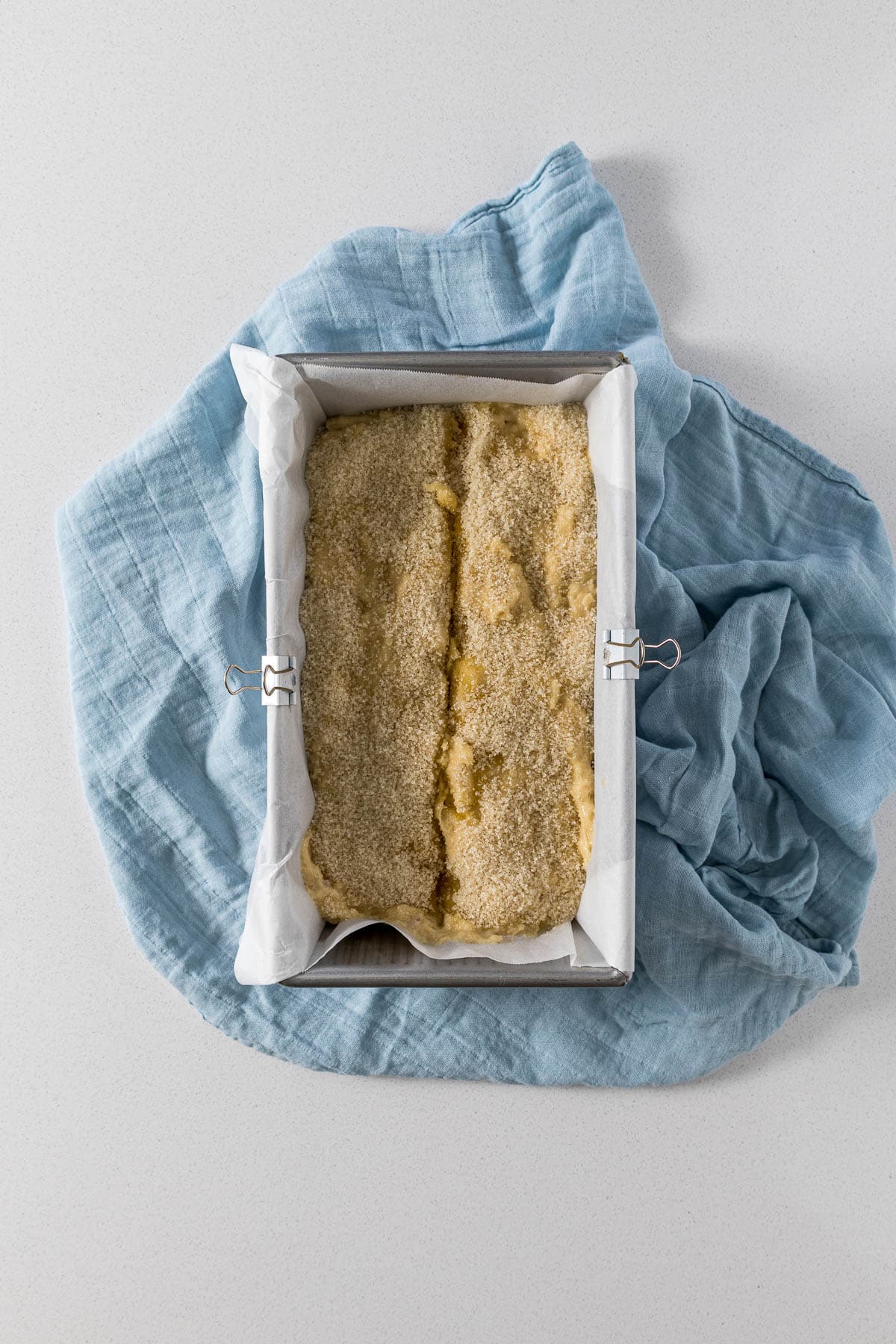 Step 6 - banana bread batter in loaf tin topped with sugar and scored down the middle.
