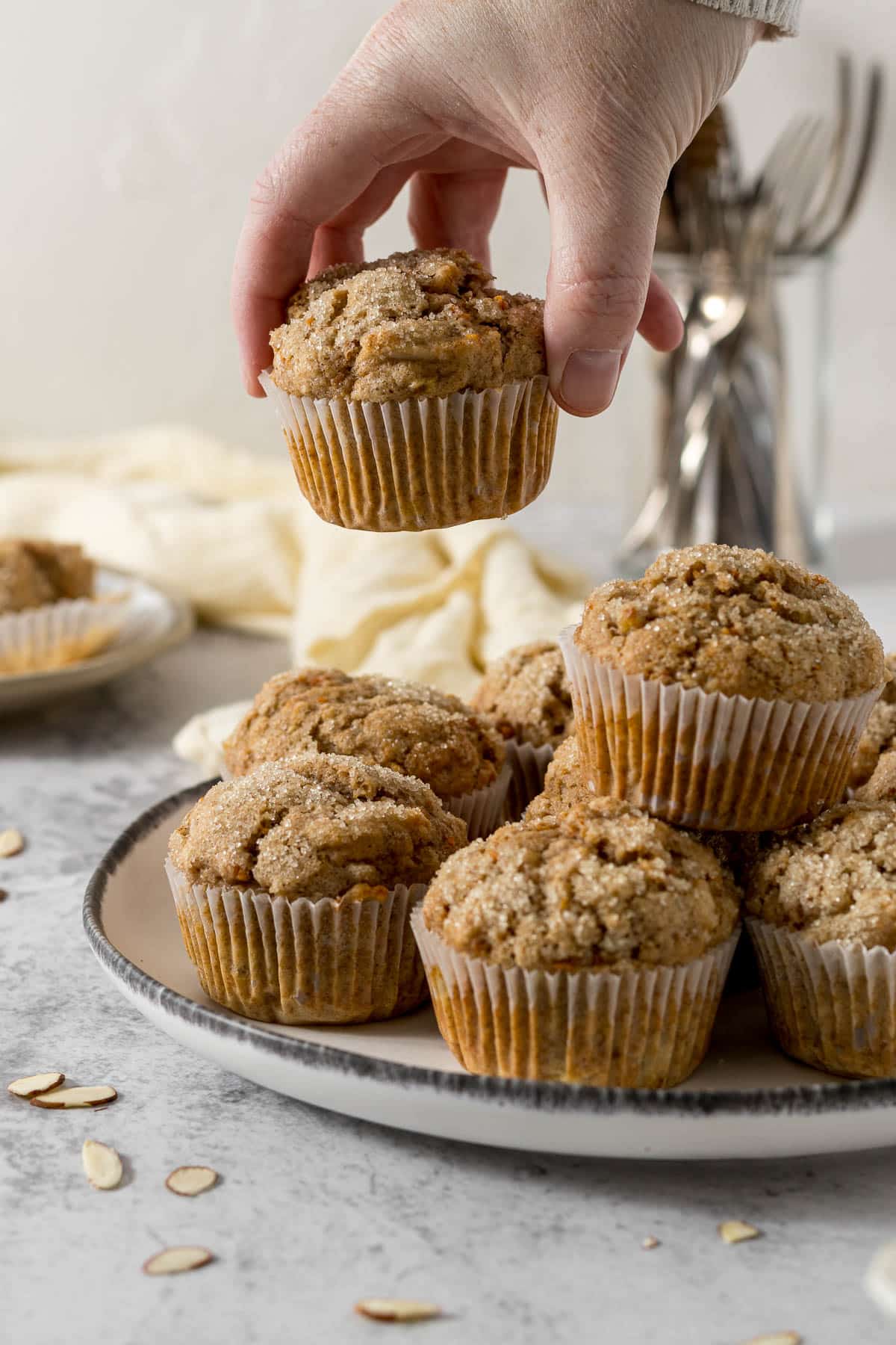 Pile of banana and carrot muffins on a plate.