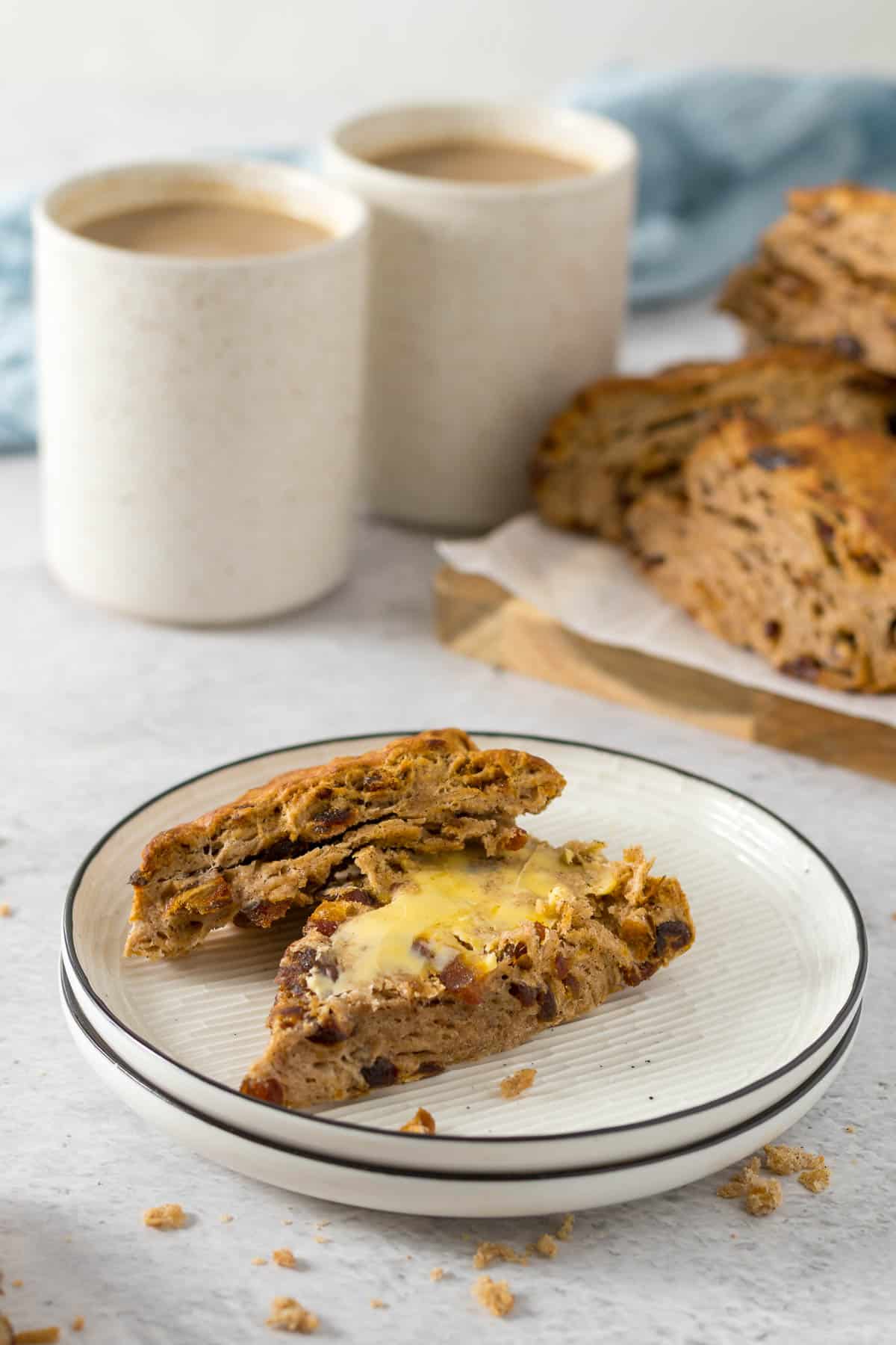 Scone served with butter on a plate.