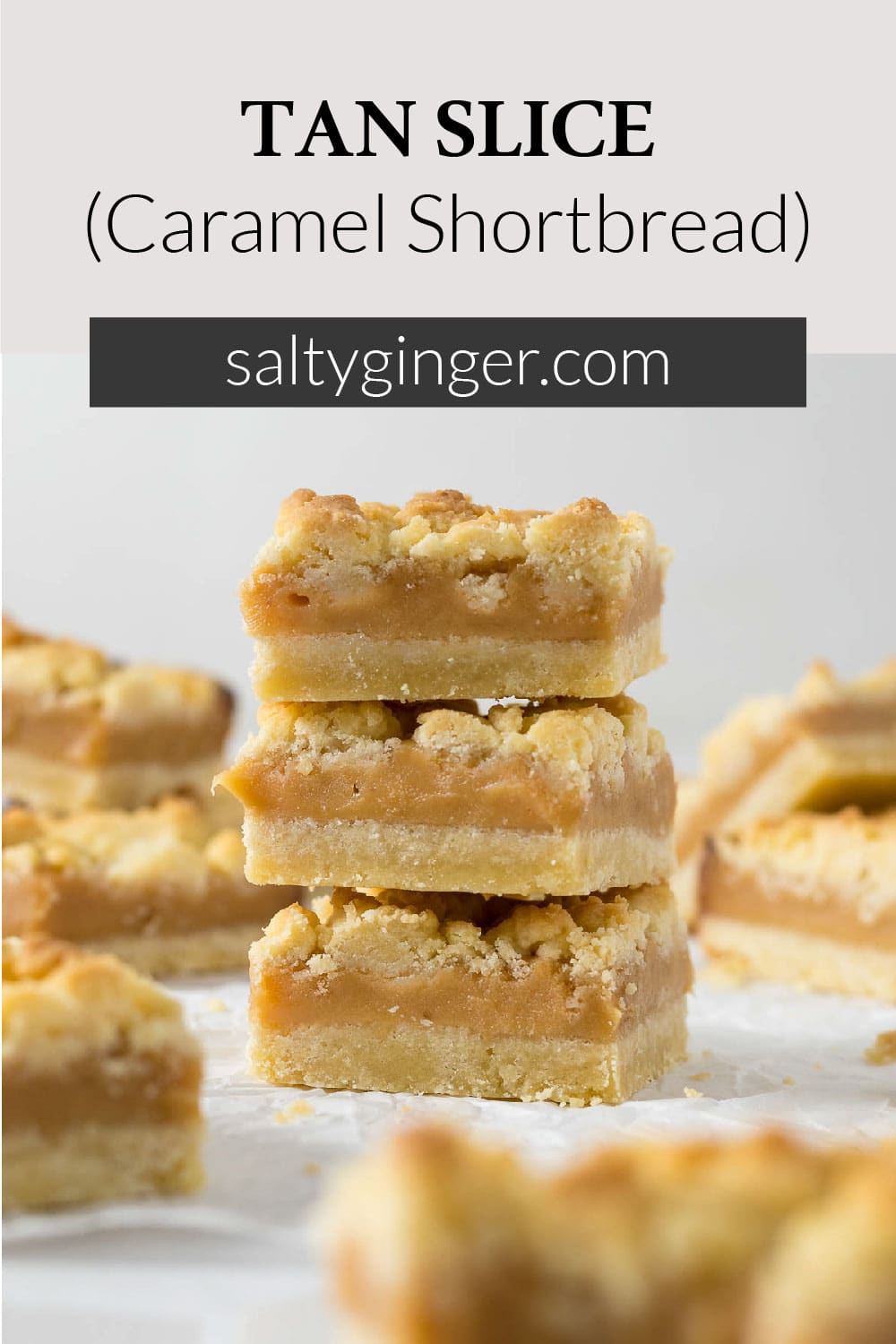 Three tan squares stacked on each other to show the layers of shortbread and caramel.