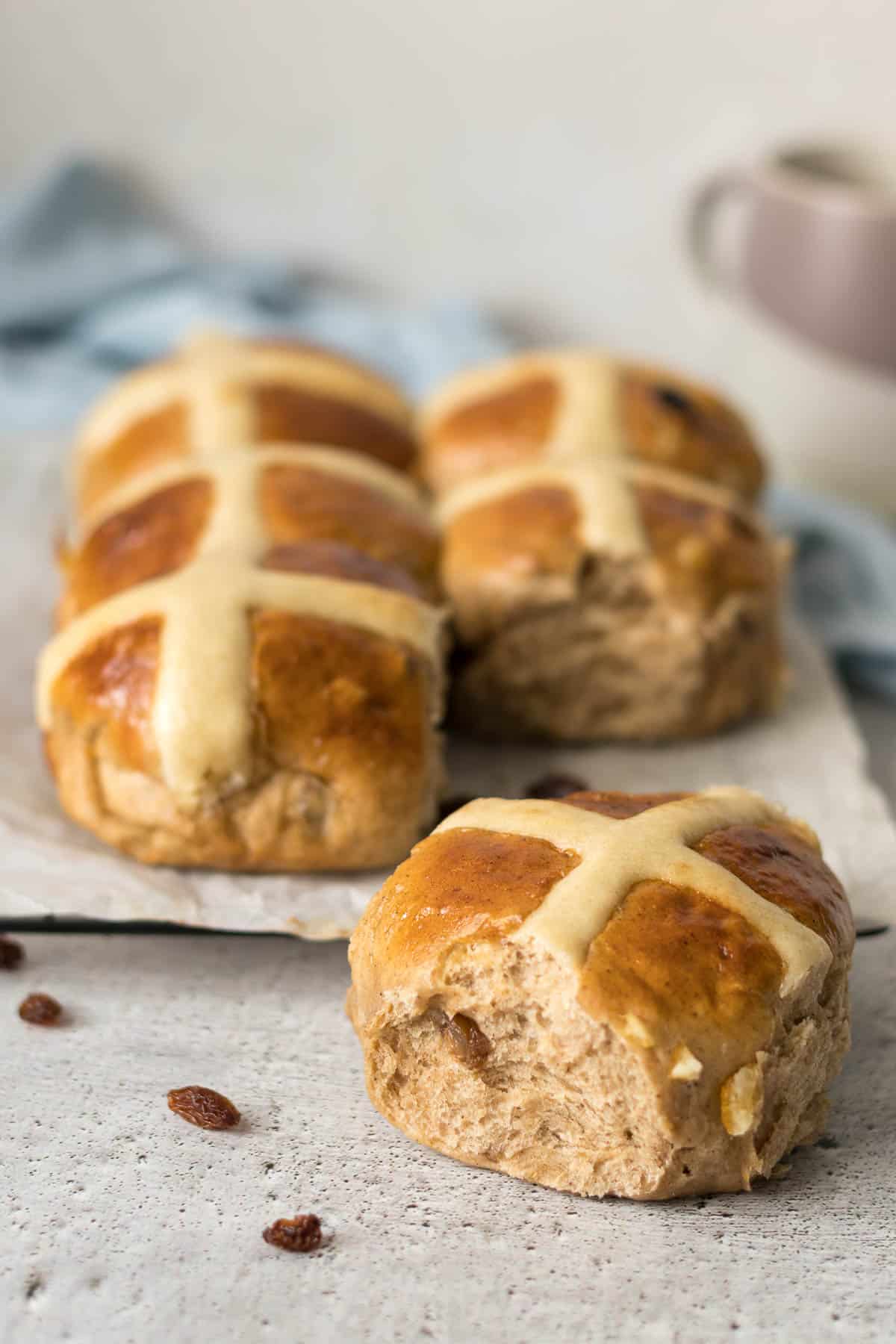 A single bun pulled out of the 6 pack of buns behind it.