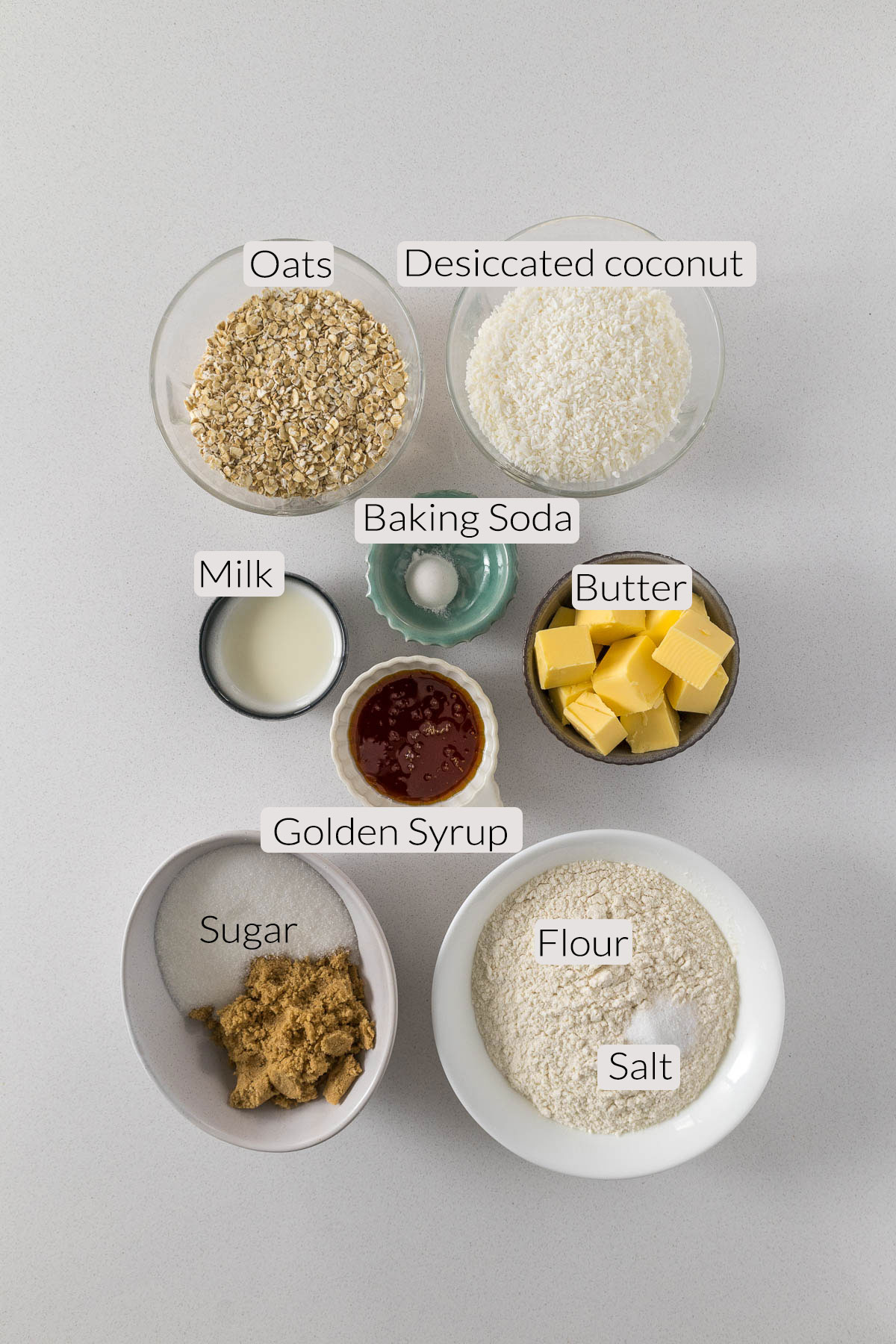 Anzac biscuits ingredients - flour, salt, sugar, golden syrup, butter, baking soda, milk, desiccated coconut and oats.