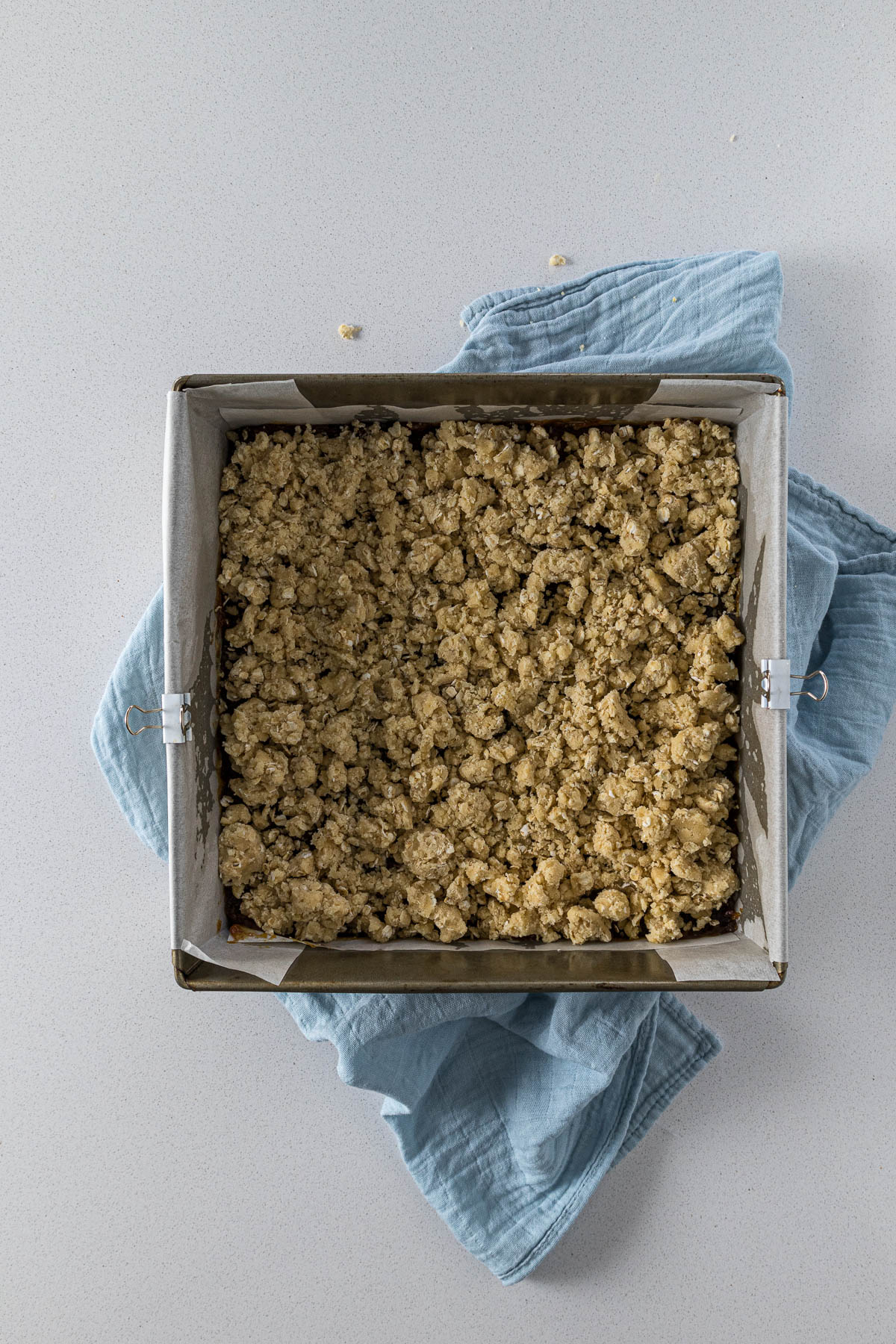 Step 7 - Oat shortbread crumble spread over the date filling.