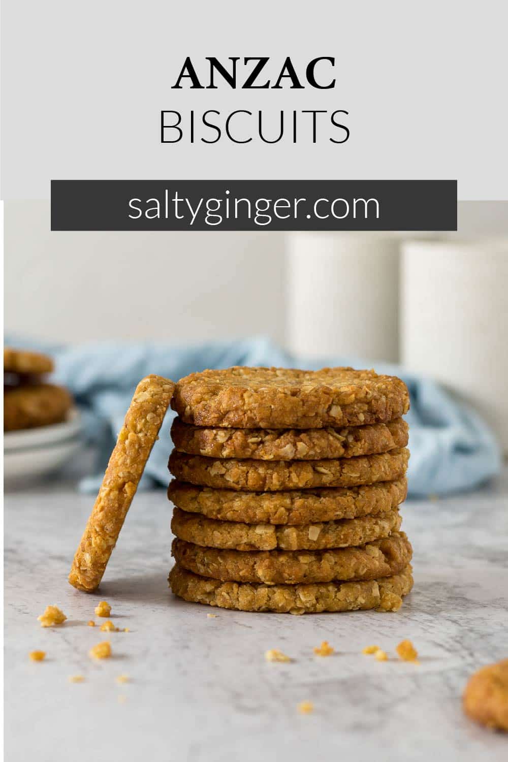 Stack of ANZAC biscuits with one propped on the side of the stack to show the side view.