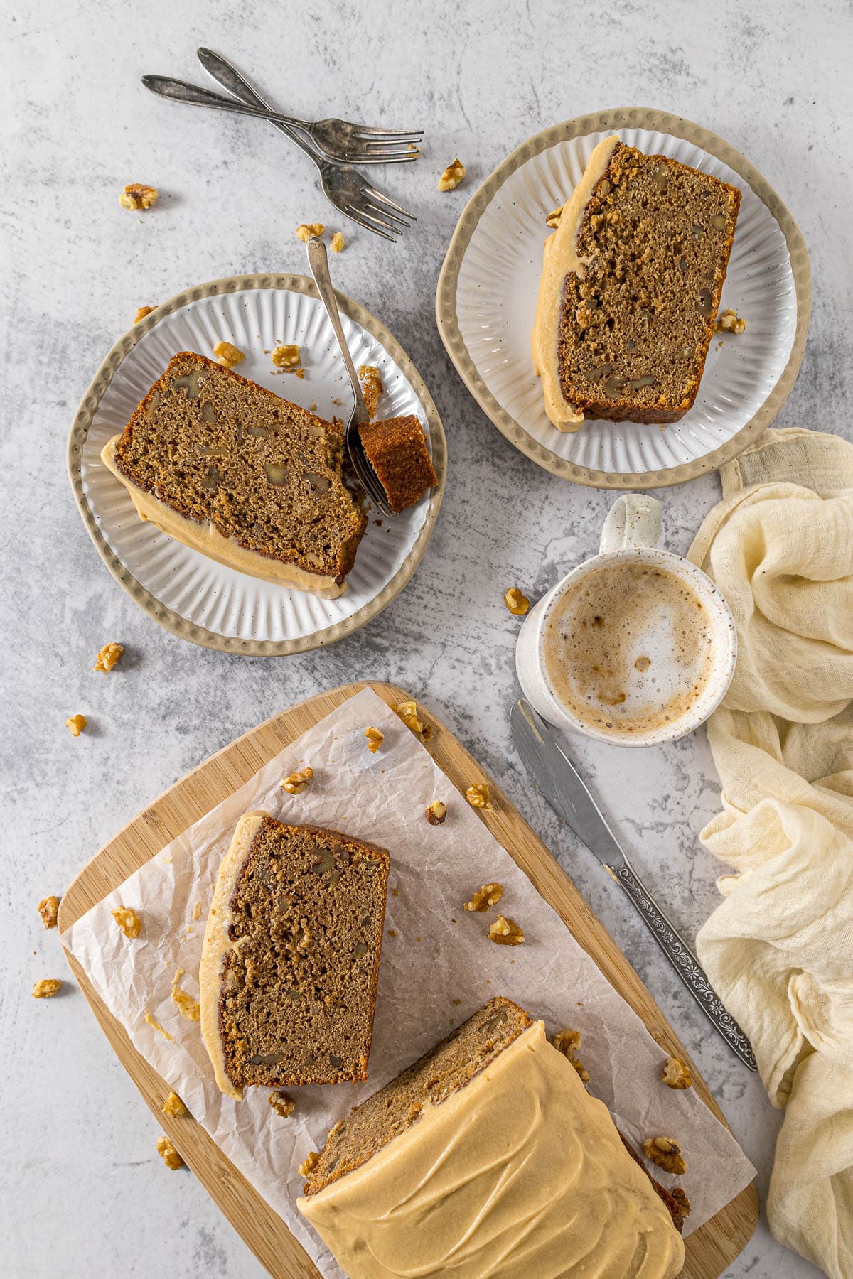 Sliced coffee and walnut cake on plates.