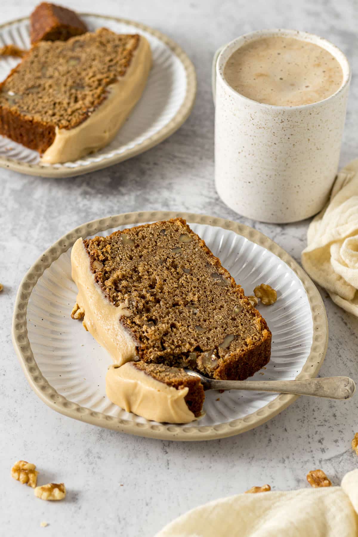 Slice of coffee and walnut loaf on a plate.