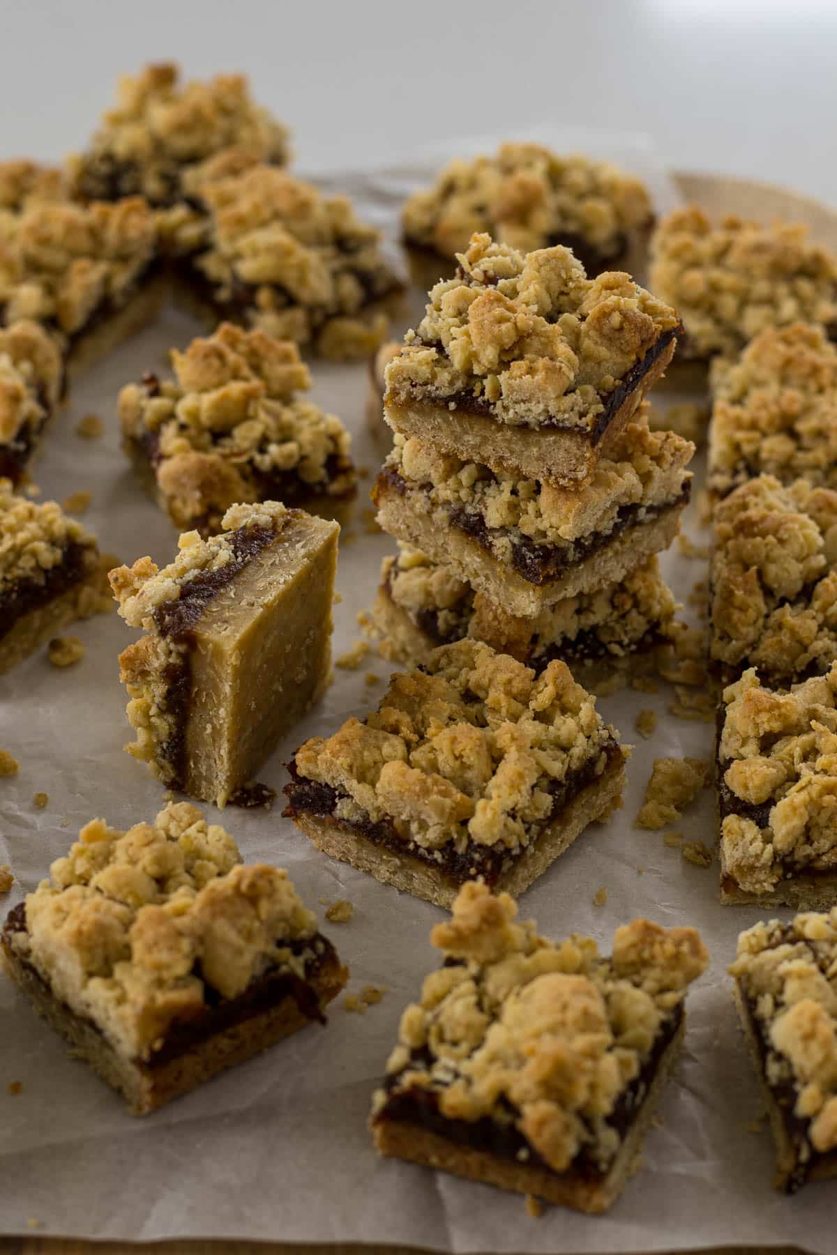 Sliced date and oat squares on parchment paper.