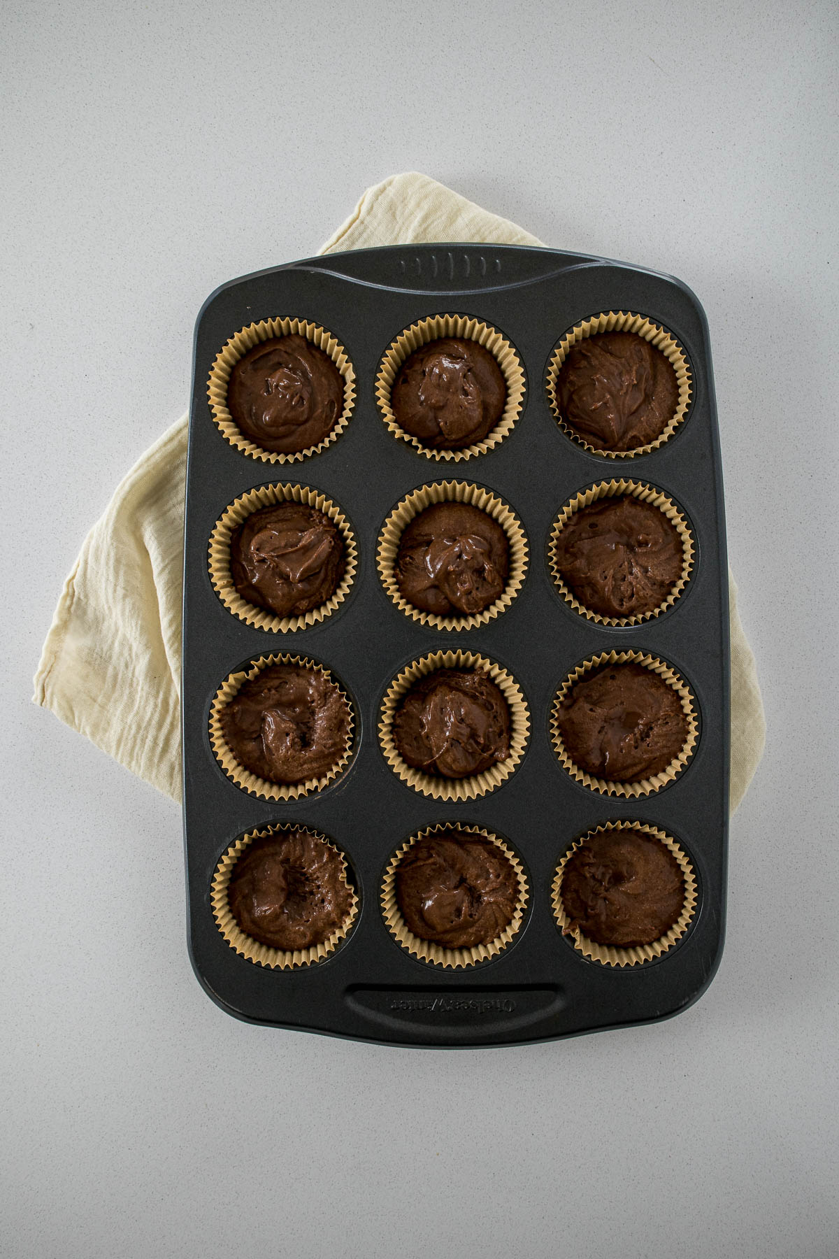 Step 7 - cupcake batter divided into cupcake liners.