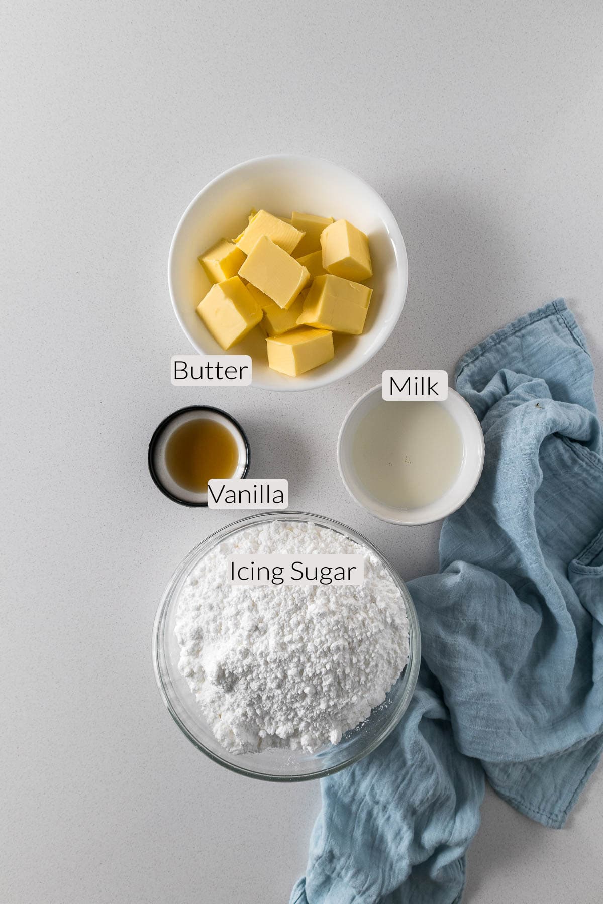 Buttercream frosting ingredients - butter, icing sugar, vanilla and milk.