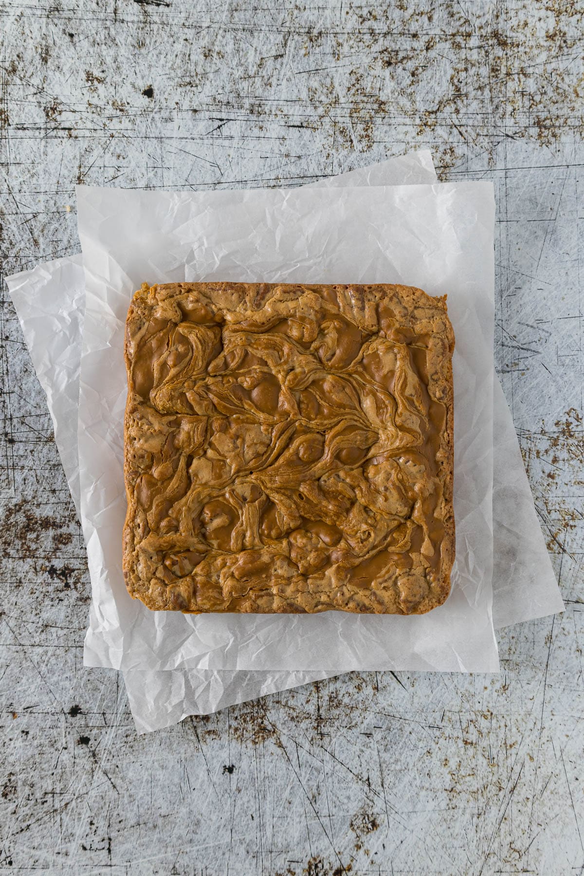 Baked Biscoff blondie on baking paper.