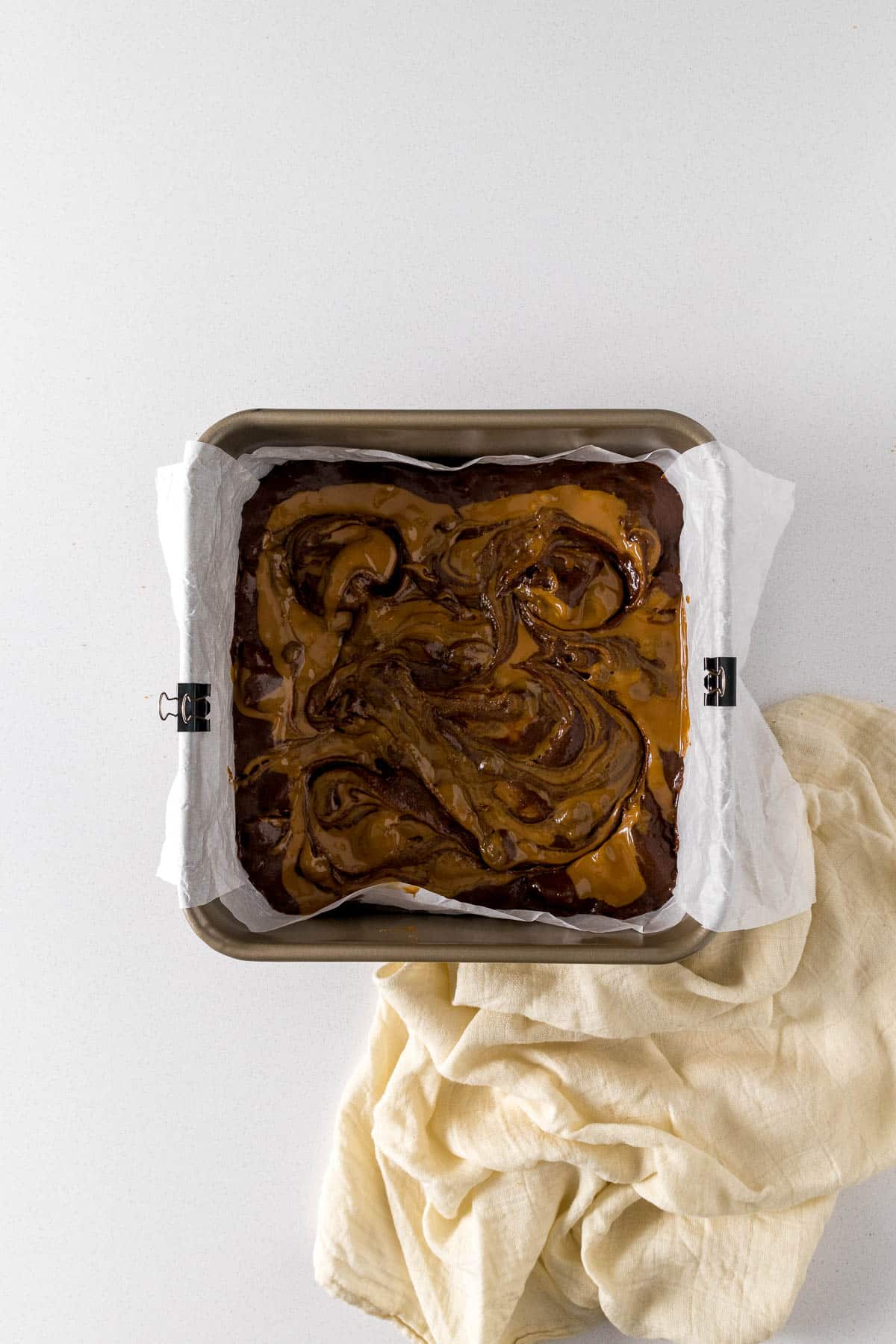Step 8 - Biscoff brownie batter poured into tin with Biscoff spread swirls.