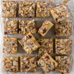 Sliced Bakewell blondies on baking paper.