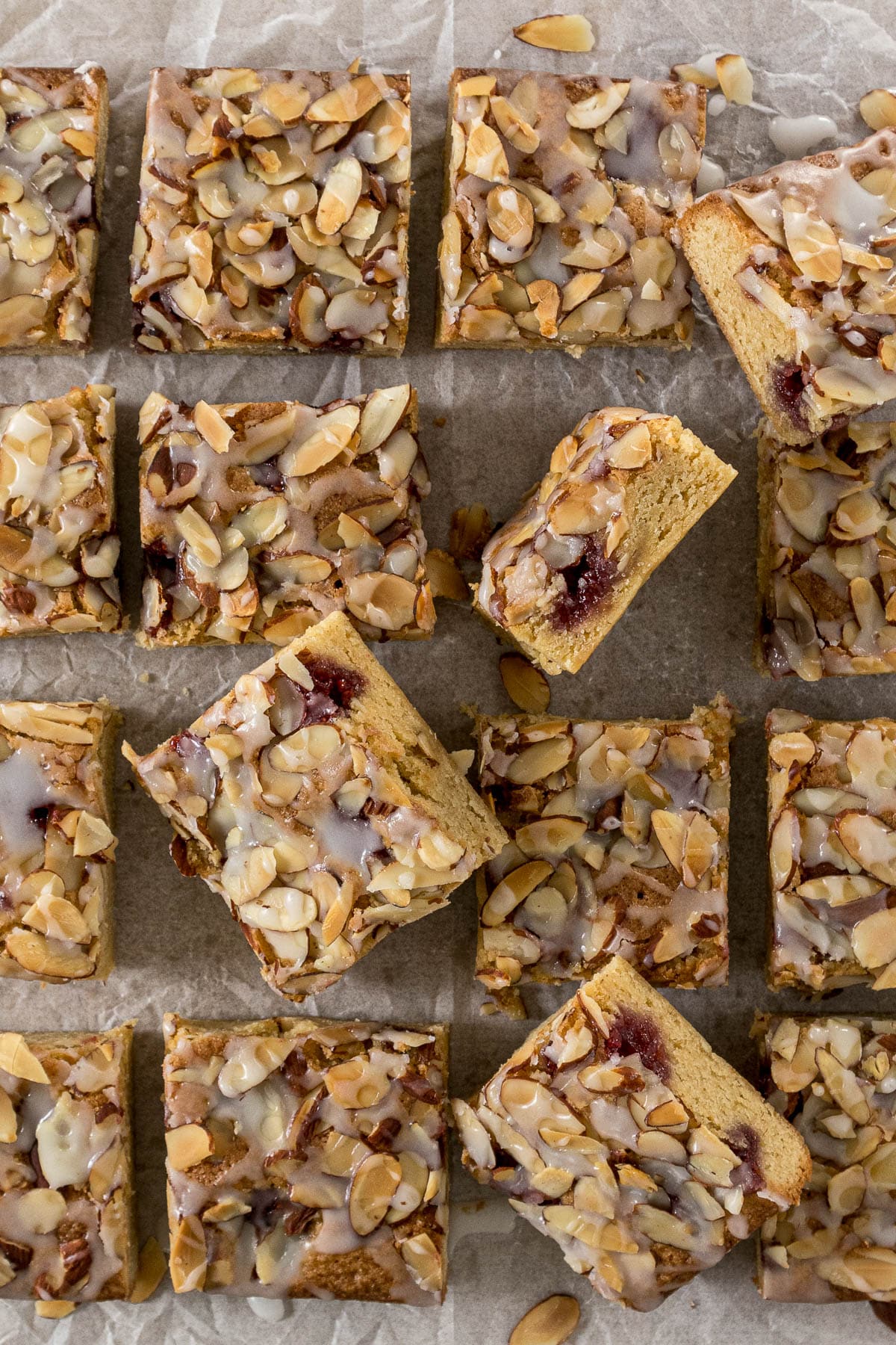 Sliced Bakewell Blondies on a baking paper.