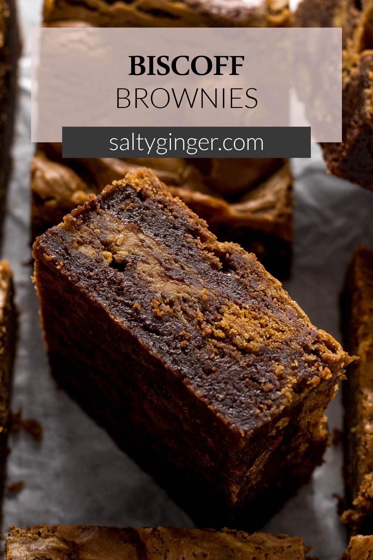 Pin - Sliced Biscoff brownie showing the cookie and biscoff swirls.