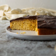 Sliced chocolate orange cake on a plate.