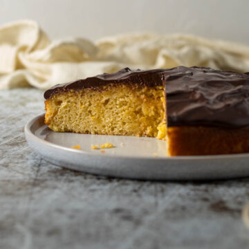 Sliced chocolate orange cake on a plate.