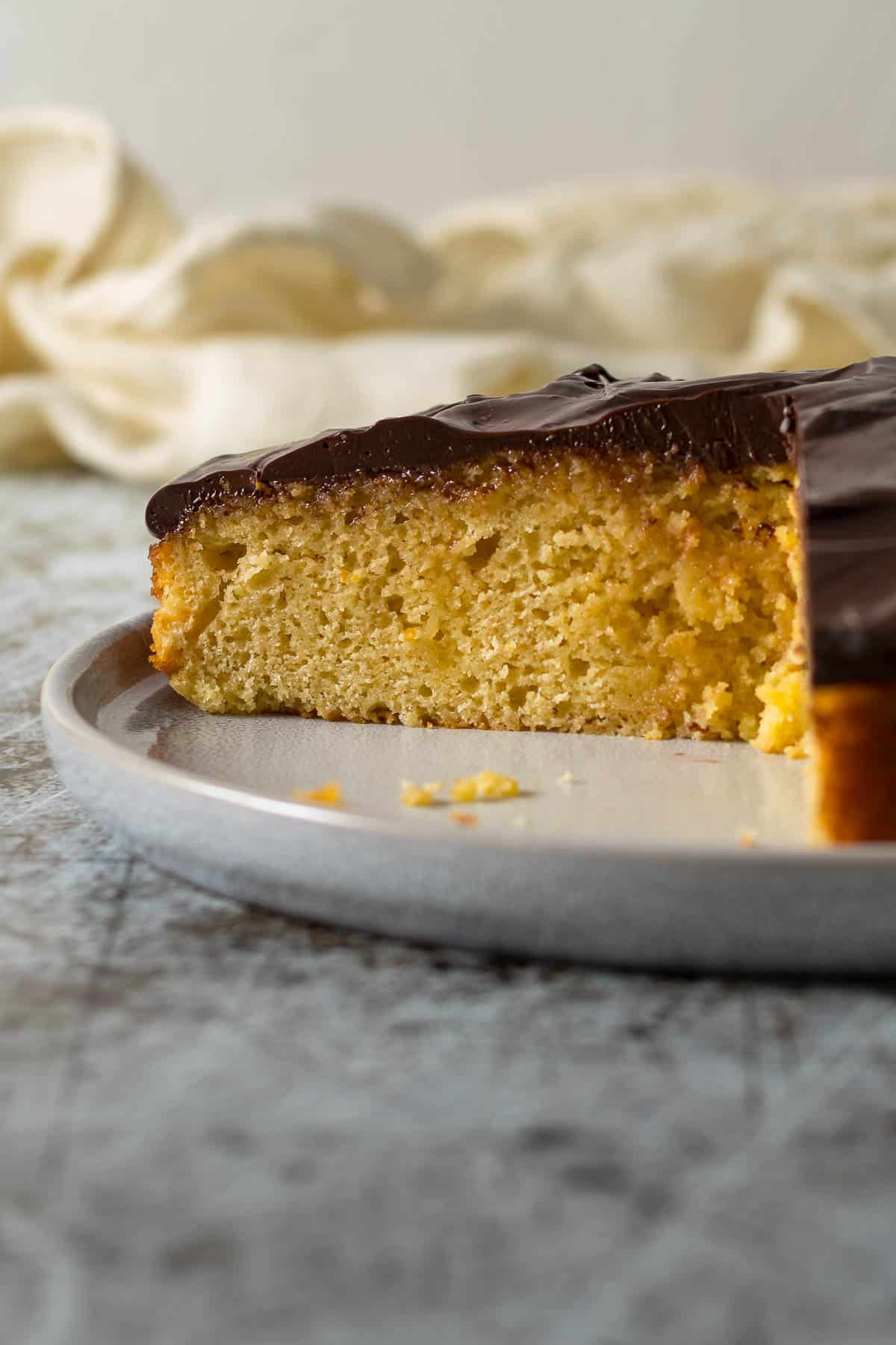 Sliced chocolate orange cake on a plate.
