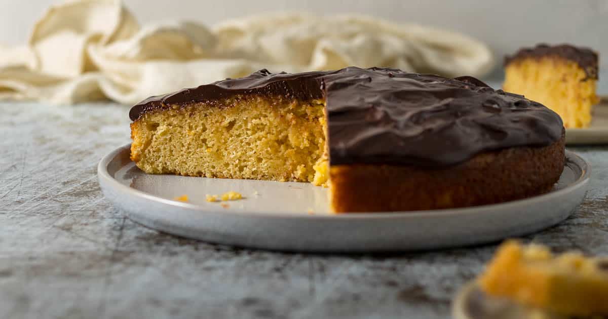 Sliced chocolate orange cake on a plate.