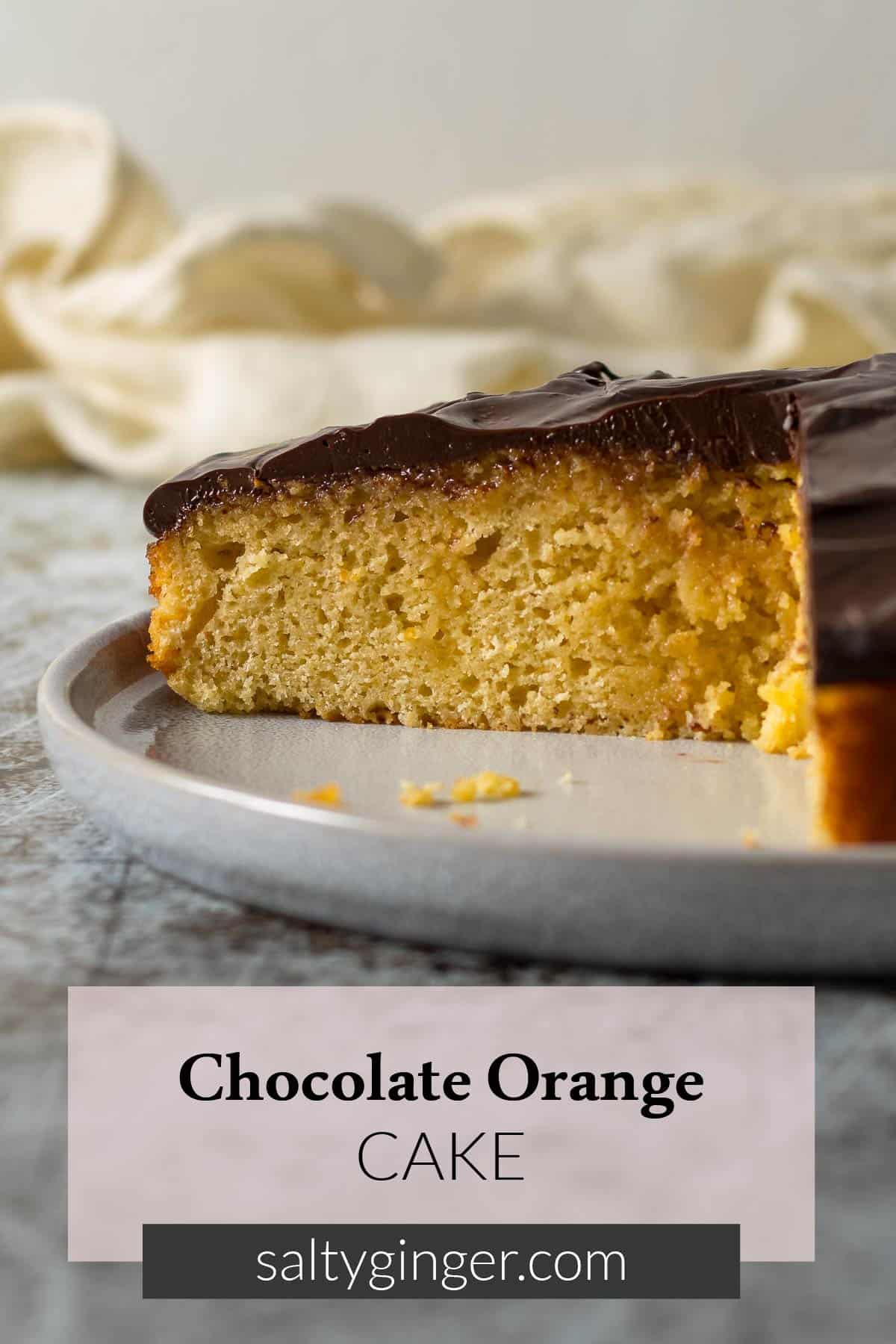 Pin - sliced orange chocolate cake on a plate.
