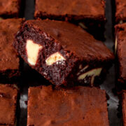 Close up of sliced red velvet brownie showing white chocolate chunks.