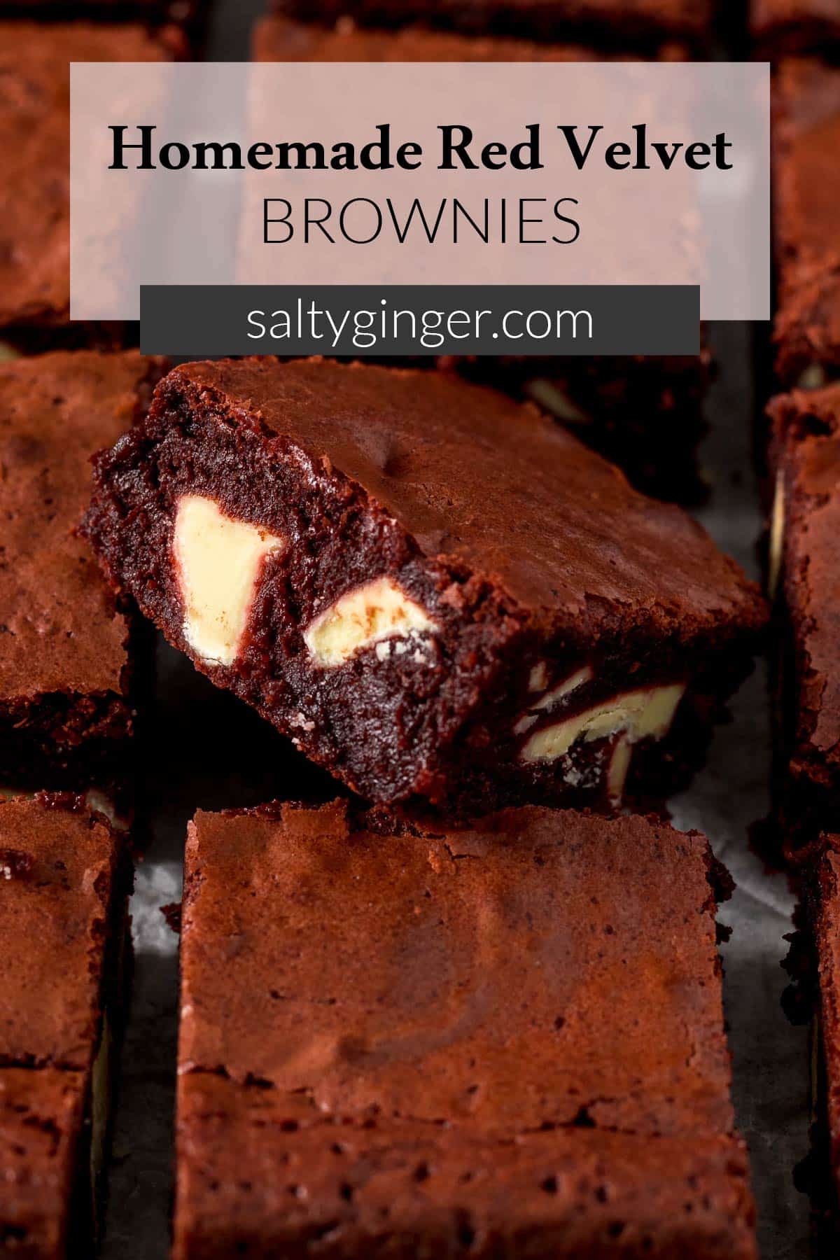 Pin - Close up of sliced red velvet brownie showing white chocolate chunks.