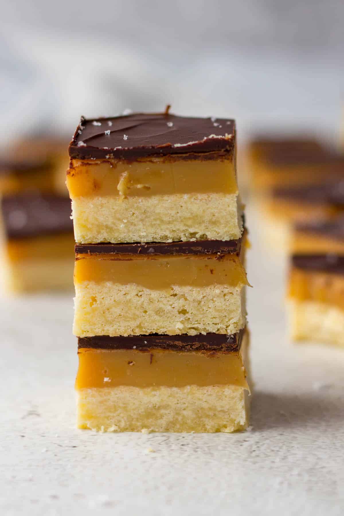 Millionaires shortbread slices stacked on each other.