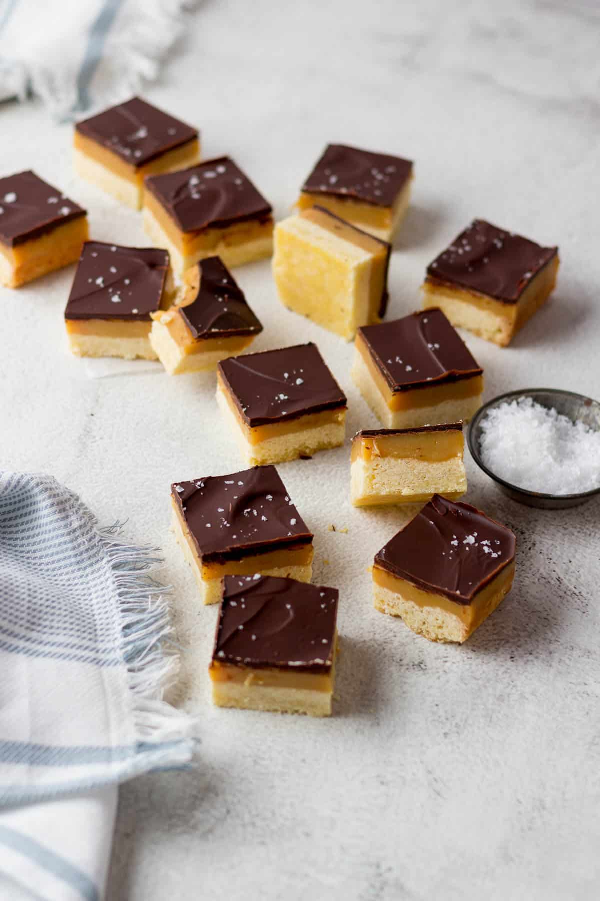Caramel slices showing shortbread, caramel and chocolate layers.
