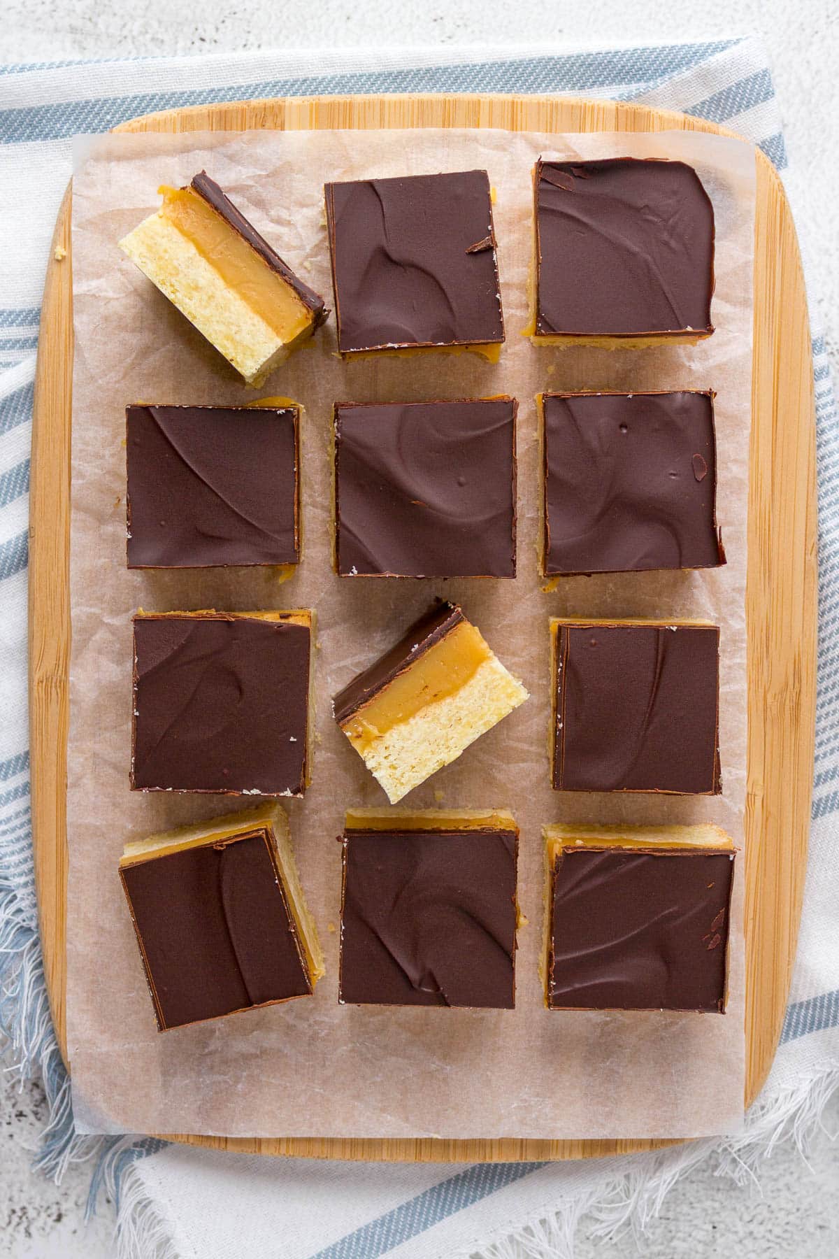Sliced millionaires shortbread on a cutting board.