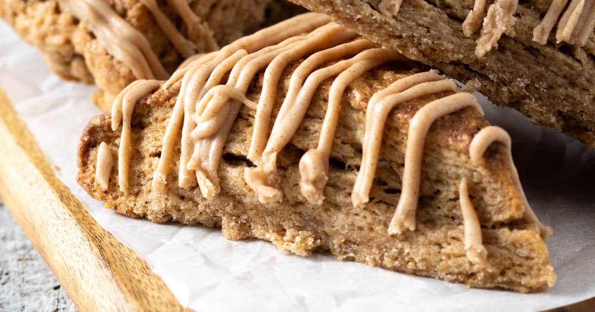 Cinnamon scones with a cinnamon glaze on a board.