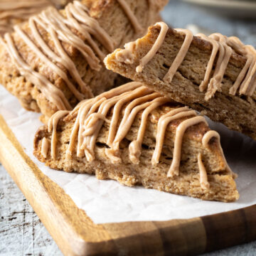 Cinnamon scones with a cinnamon glaze on a board.